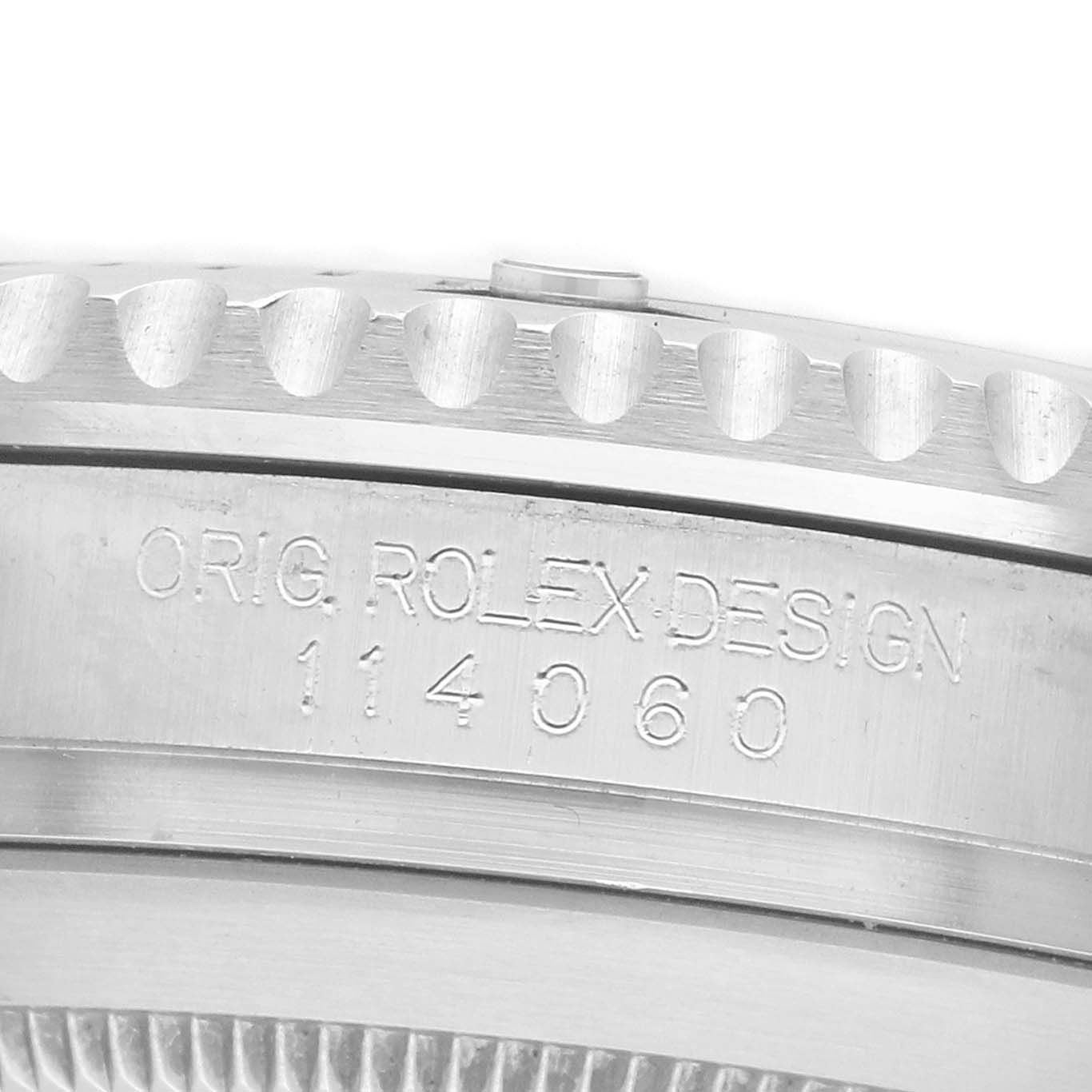 The image shows a side view of the bezel and engraved case side of a Rolex Submariner 114060 Men's Stainless Steel Black Dial watch.