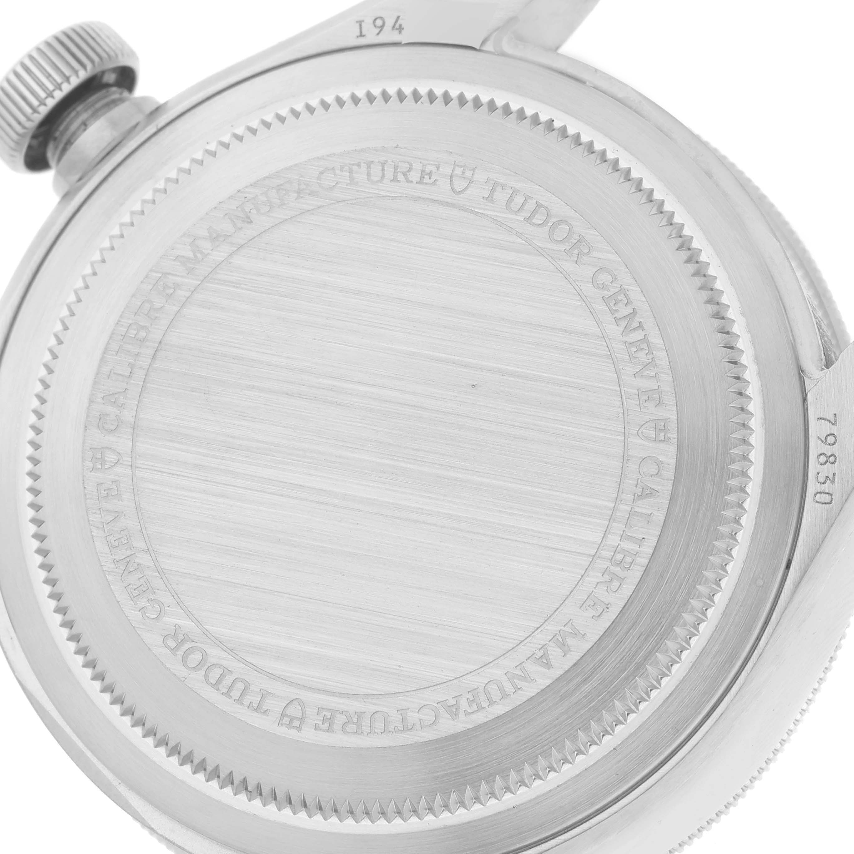 This image shows the back case of a Tudor Heritage Black Bay 79830RB Men's Stainless Steel Black Dial 79830RB Men's Stainless Steel Black Dial watch, displaying its detailed engravings and brushed finish.