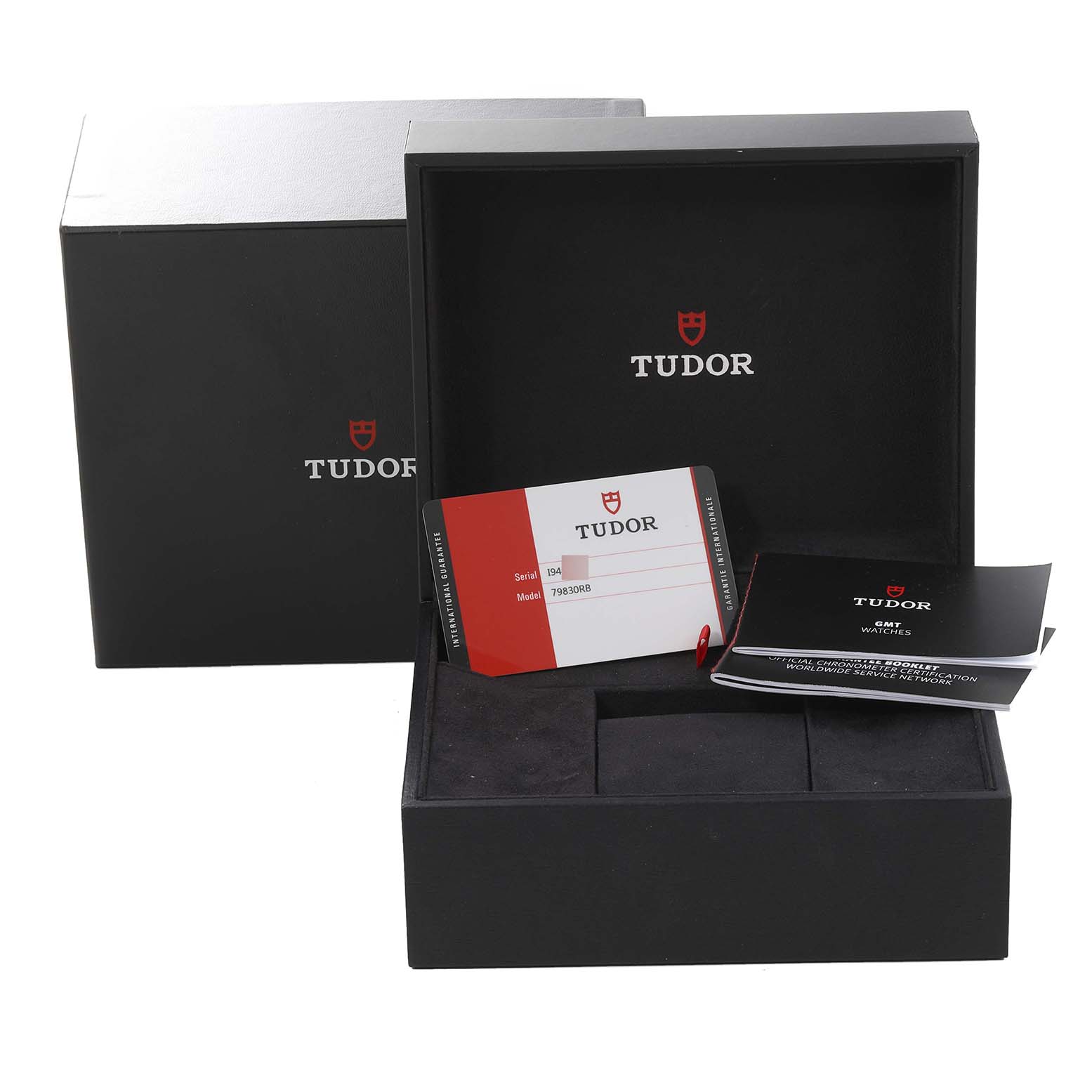 The image shows the packaging and accessories for the Tudor Heritage Black Bay 79830RB Men's Stainless Steel Black Dial 79830RB Men's Stainless Steel Black Dial watch, including the box, warranty card, and manual.