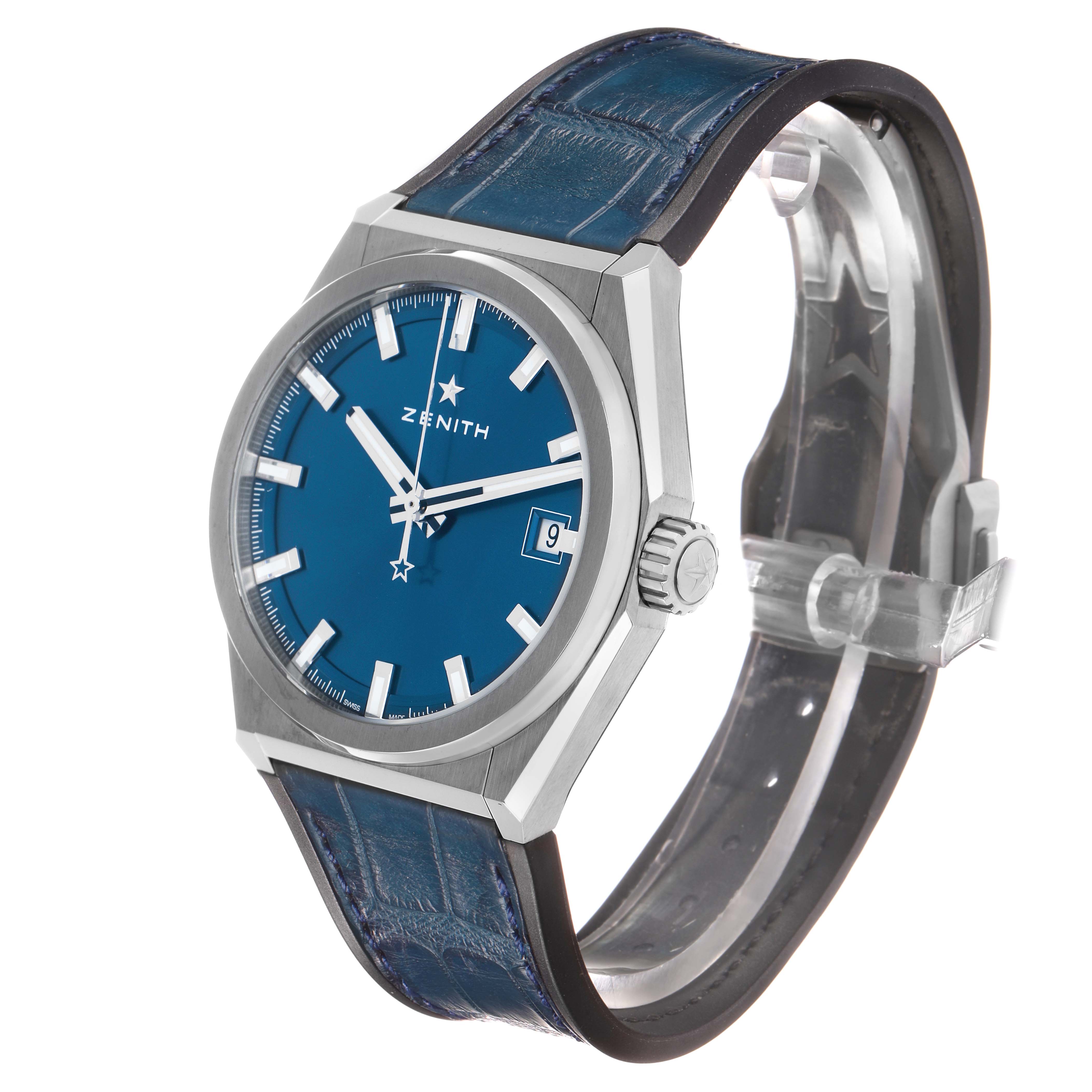 The Zenith Defy 95.9000.670/51 Men's Titanium Blue Dial watch is shown at a three-quarter angle, displaying the face, crown, and part of the blue leather strap.