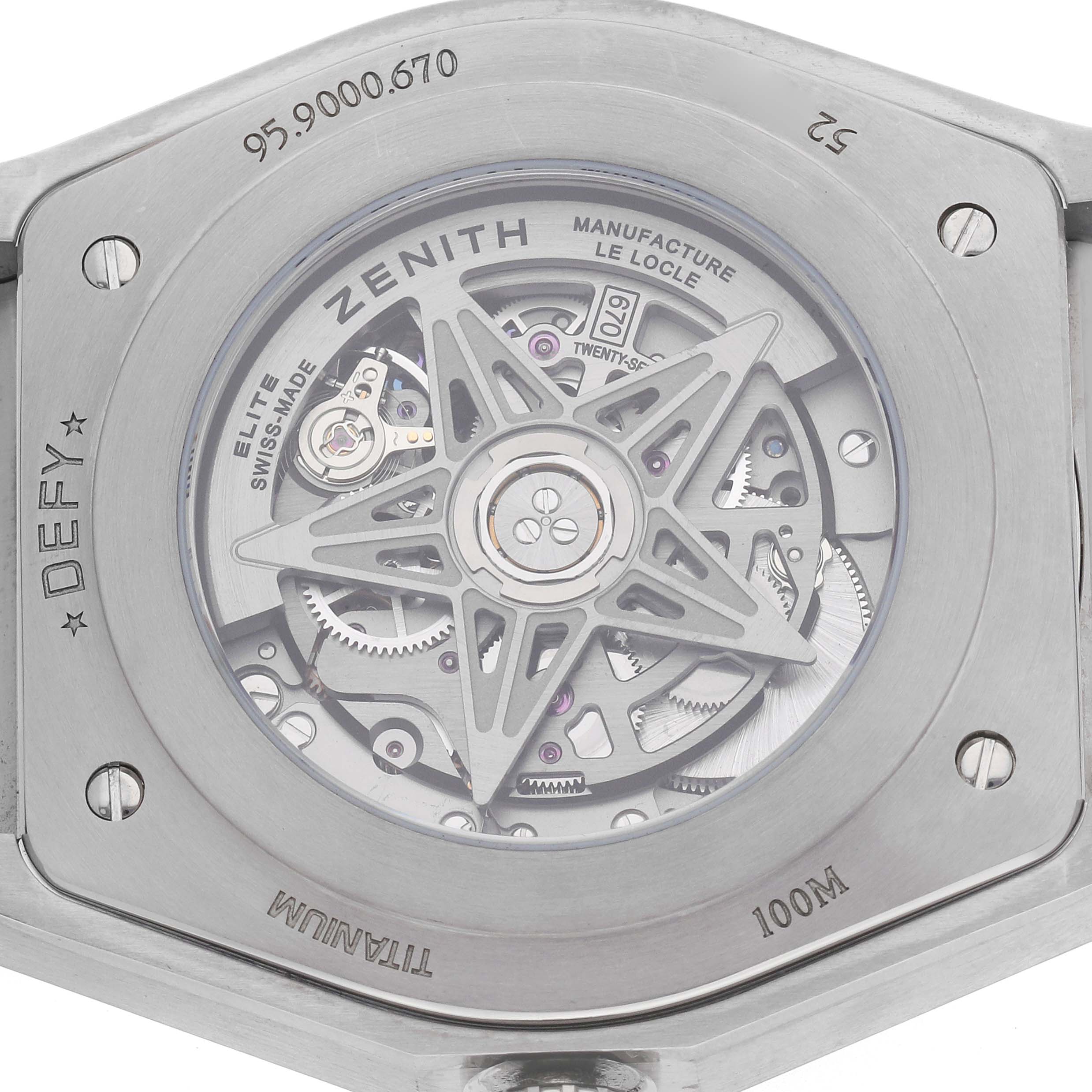 The image shows the back view of a Zenith Defy 95.9000.670/51 Men's Titanium Blue Dial watch, showcasing the intricate movement and titanium case details.