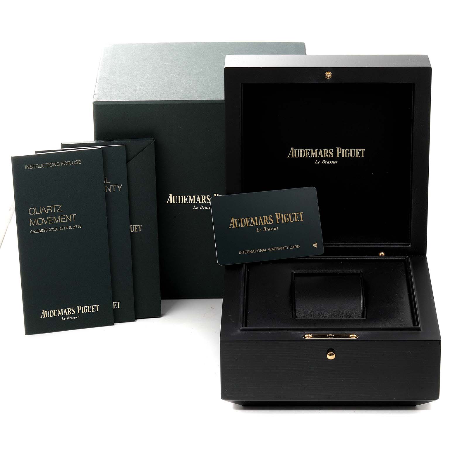The image shows the packaging and accessories for the Audemars Piguet Royal Oak 67651ST.ZZ.1261ST.01 Women's Stainless Steel Silver Dial 67651ST.ZZ.1261ST.01 Women's Stainless Steel Silver Dial, including its box, warranty card, and instruction booklets.