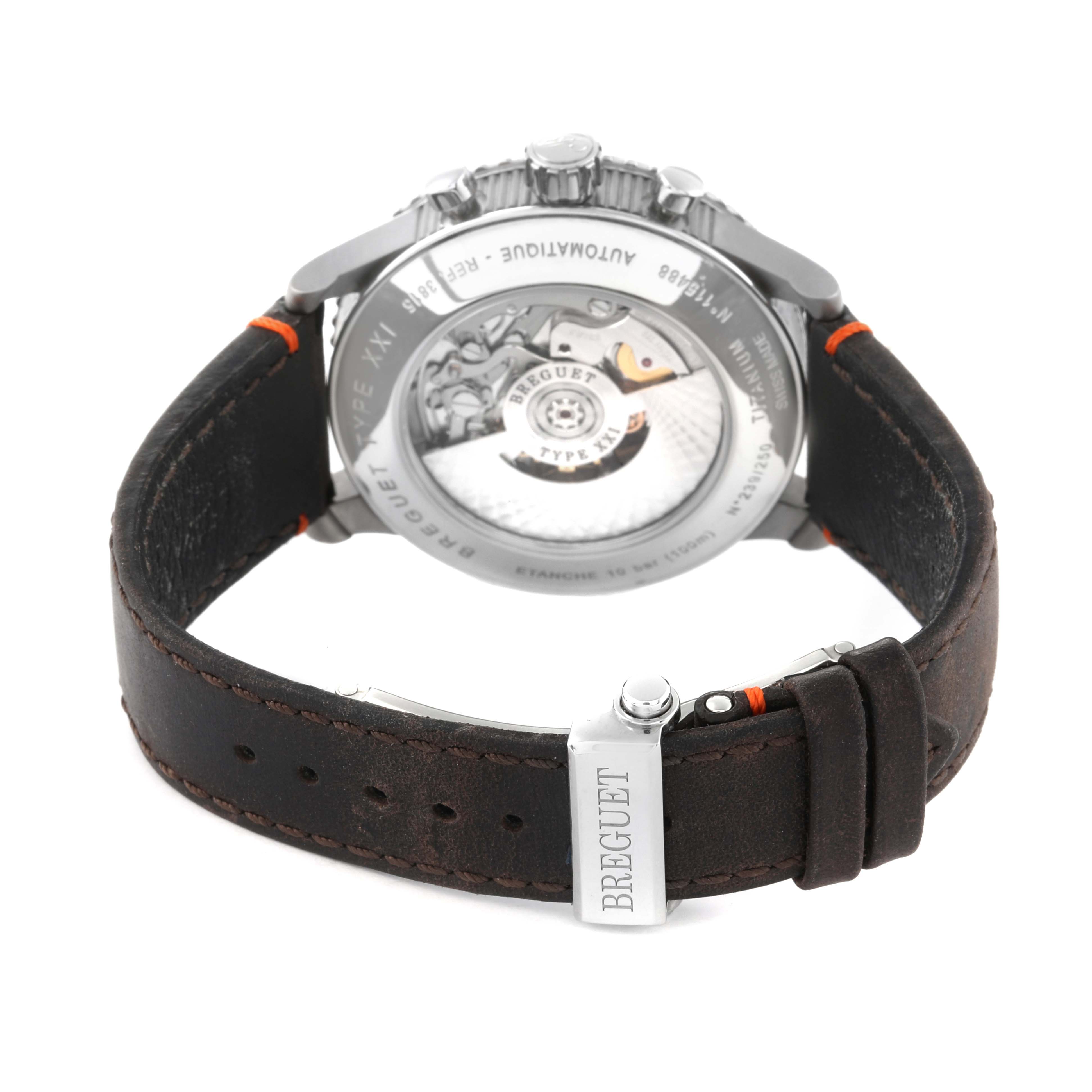 The image shows the back view of a Breguet Type XXI watch, highlighting its movement and leather strap with a clasp.