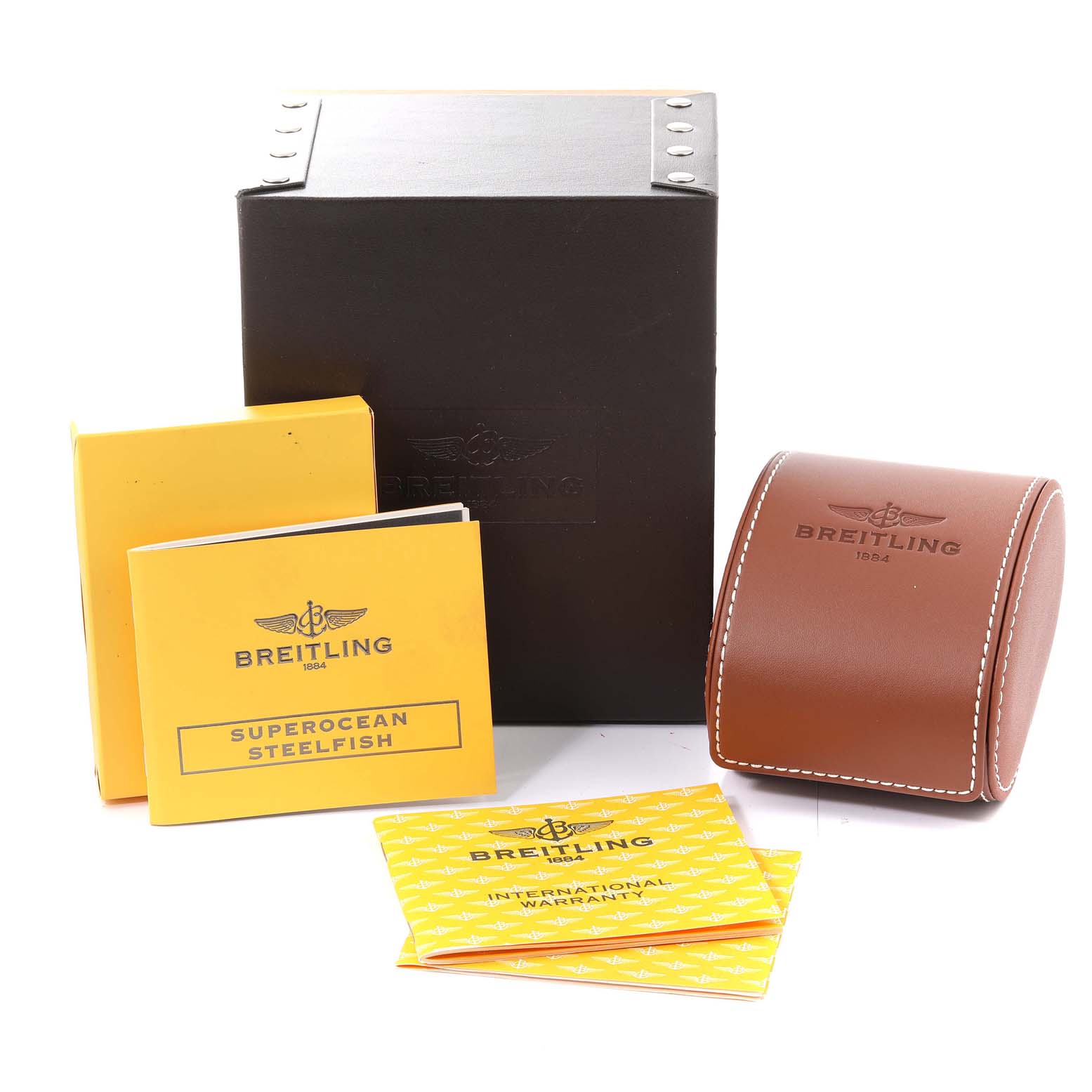 The image shows packaging and accessories for the Breitling Superocean A17390 Men's Stainless Steel Blue Dial A17390 Men's Stainless Steel Blue Dial model, including booklets, a leather case, and a box.