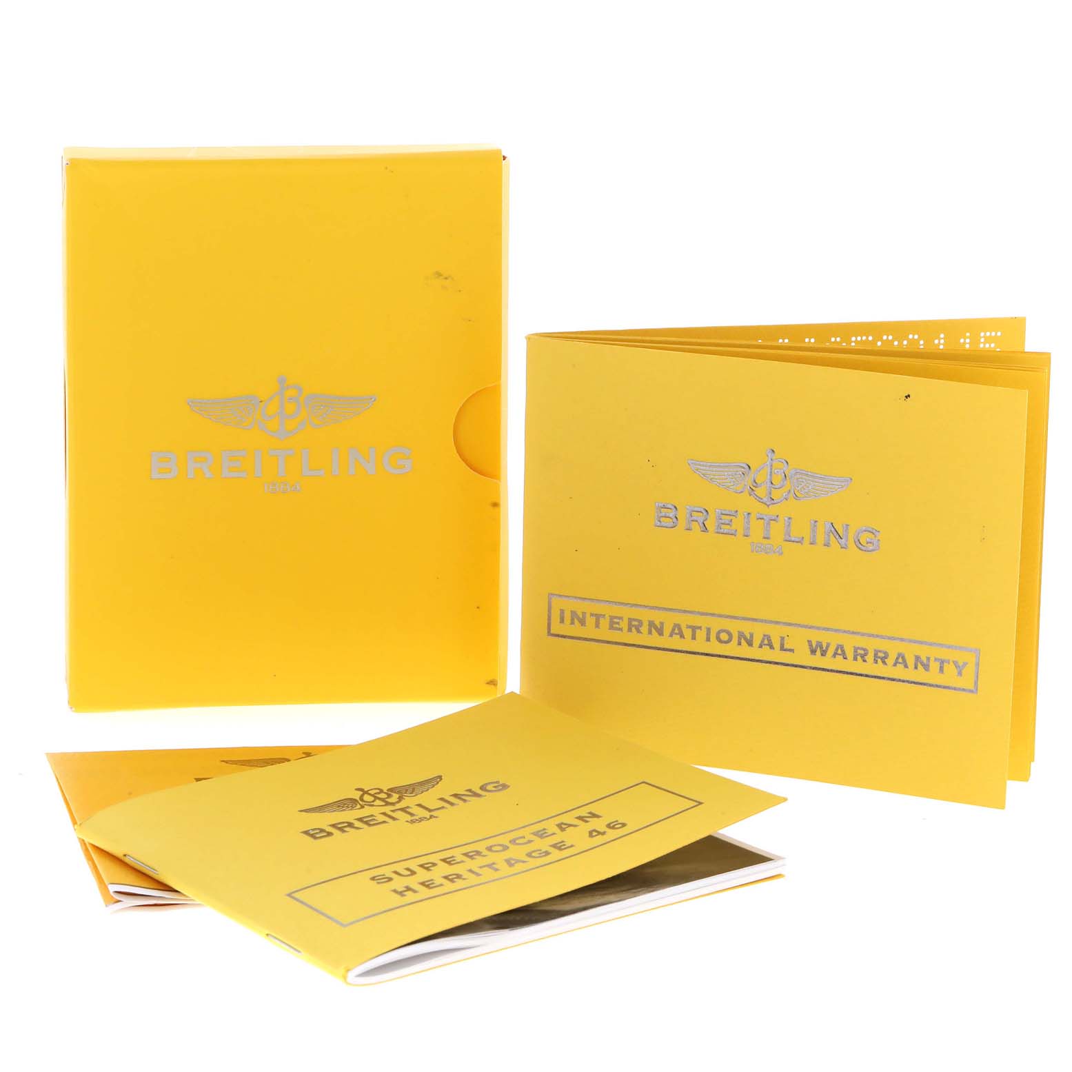 This image shows booklets and packaging materials for the Breitling Superocean A17320 Men's Stainless Steel Brown Dial A17320 Men's Stainless Steel Brown Dial model, including the international warranty card.