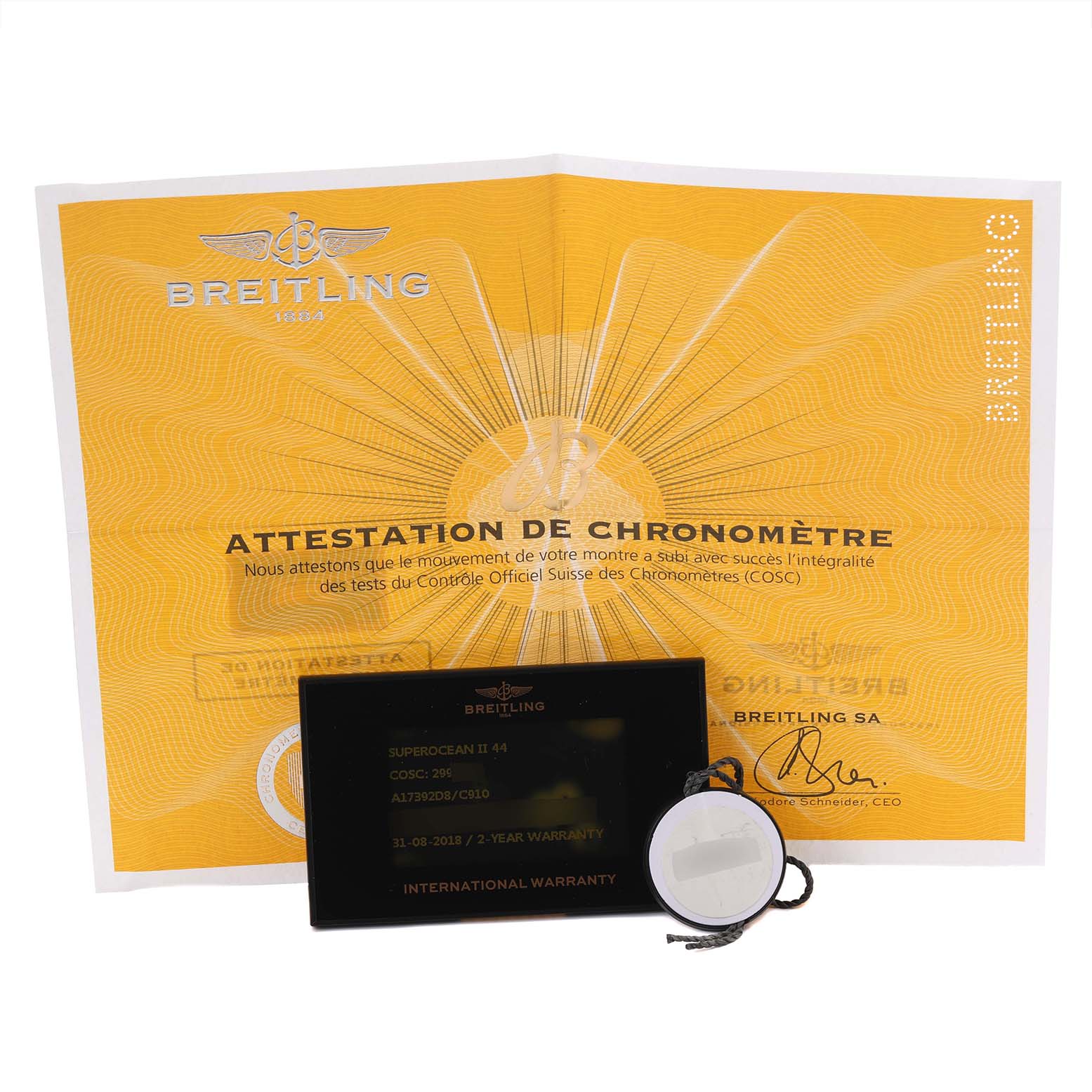 The image shows the Breitling Superocean A17392 Men's Stainless Steel Blue Dial A17392 Men's Stainless Steel Blue Dial certificate, warranty card, and tag from a top-down angle.