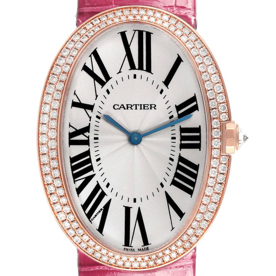 The Cartier Baignoire watch is shown from the front, highlighting its oval dial, Roman numerals, and diamond-set bezel.