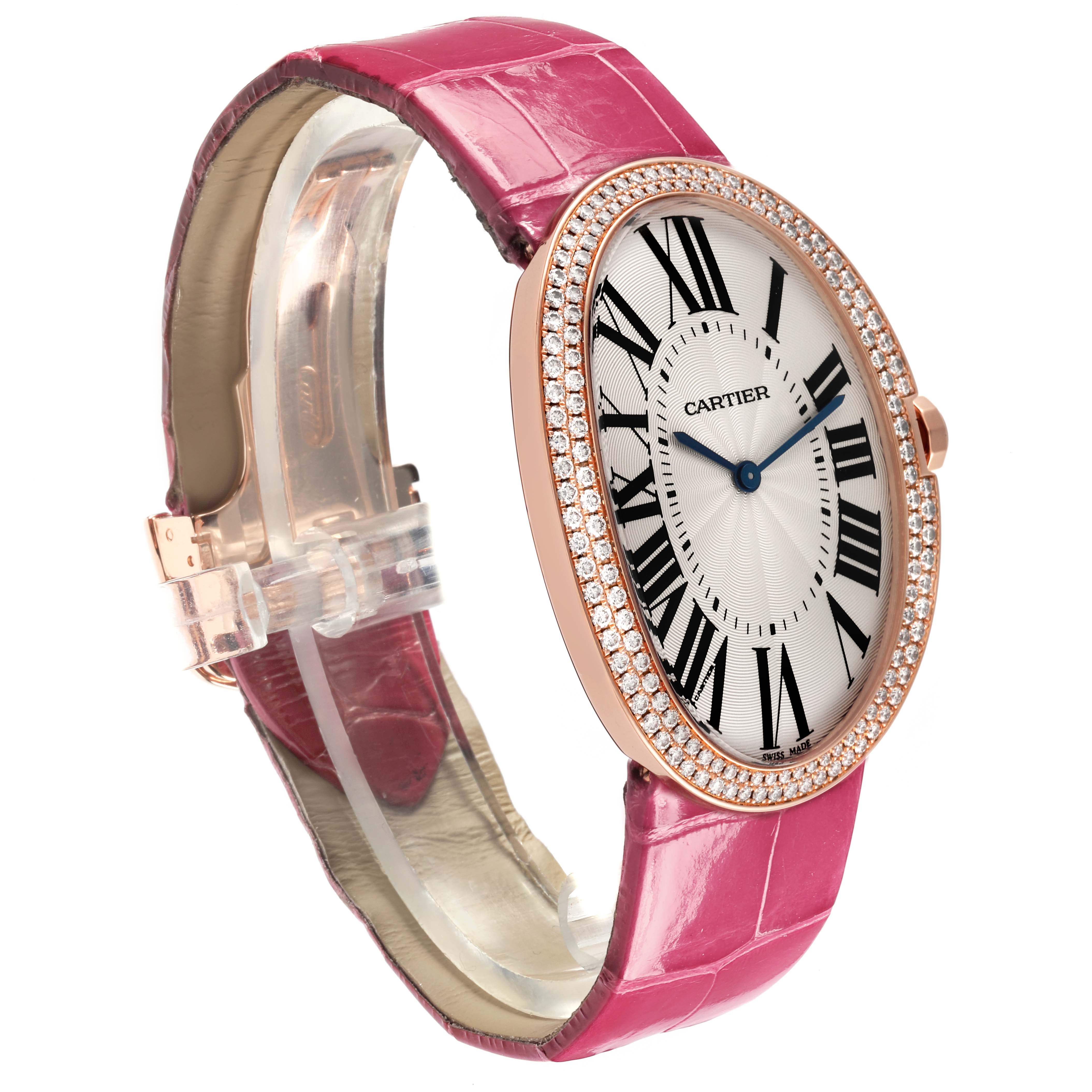 The Cartier Baignoire WB520005 Women
s Rose Gold Silver Dial WB520005 Women
s Rose Gold Silver Dial watch is shown at a side angle, highlighting its oval face, Roman numerals, diamond bezel, and pink strap.
