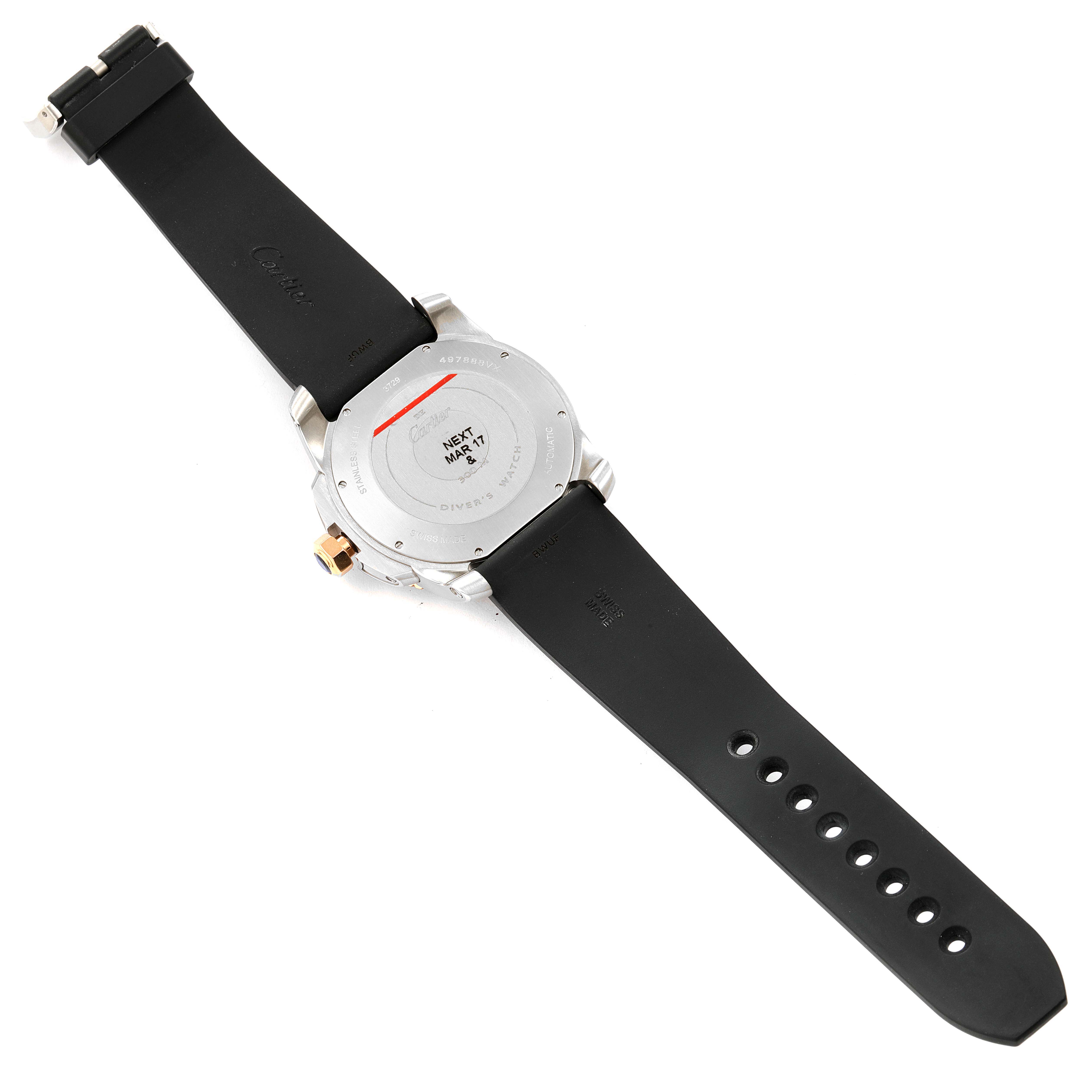 The image shows the back view of a Calibre de Cartier watch by Cartier, featuring its case back and black rubber strap.