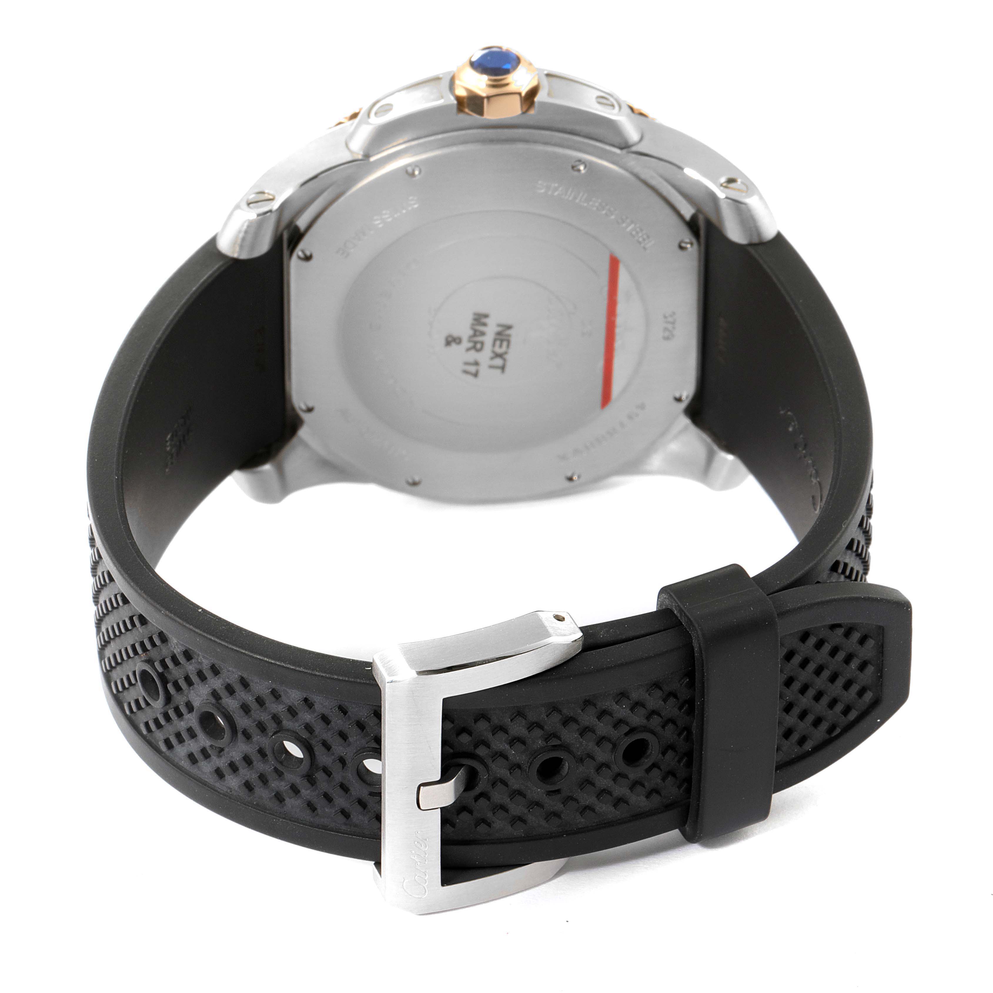 The image shows the back view of the Calibre de Cartier watch by Cartier, highlighting the case back and black rubber strap with a buckle.