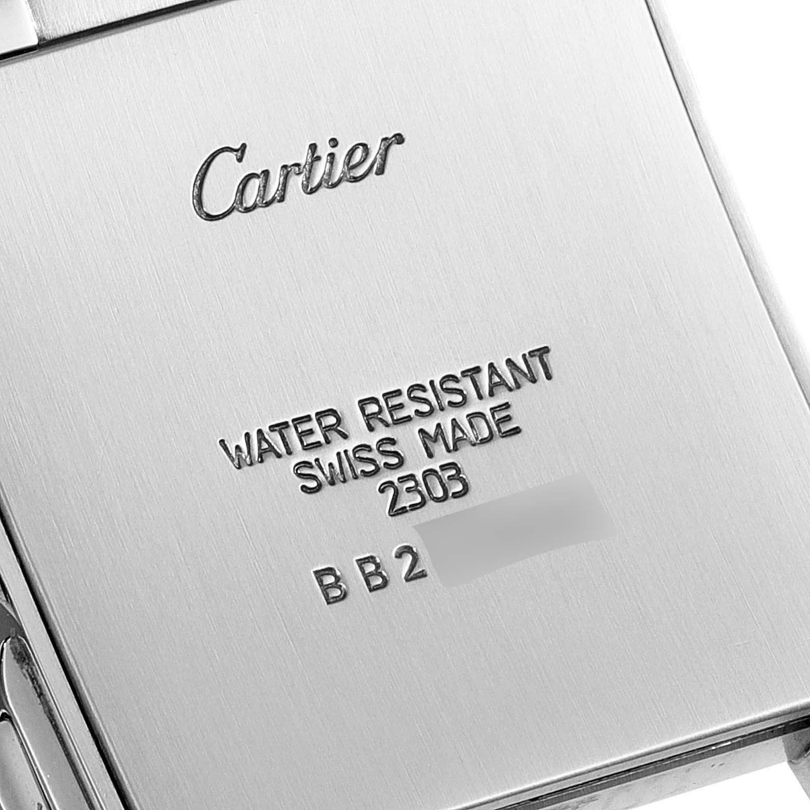 The image shows the back case of a Cartier Tank Française watch, highlighting the engravings.