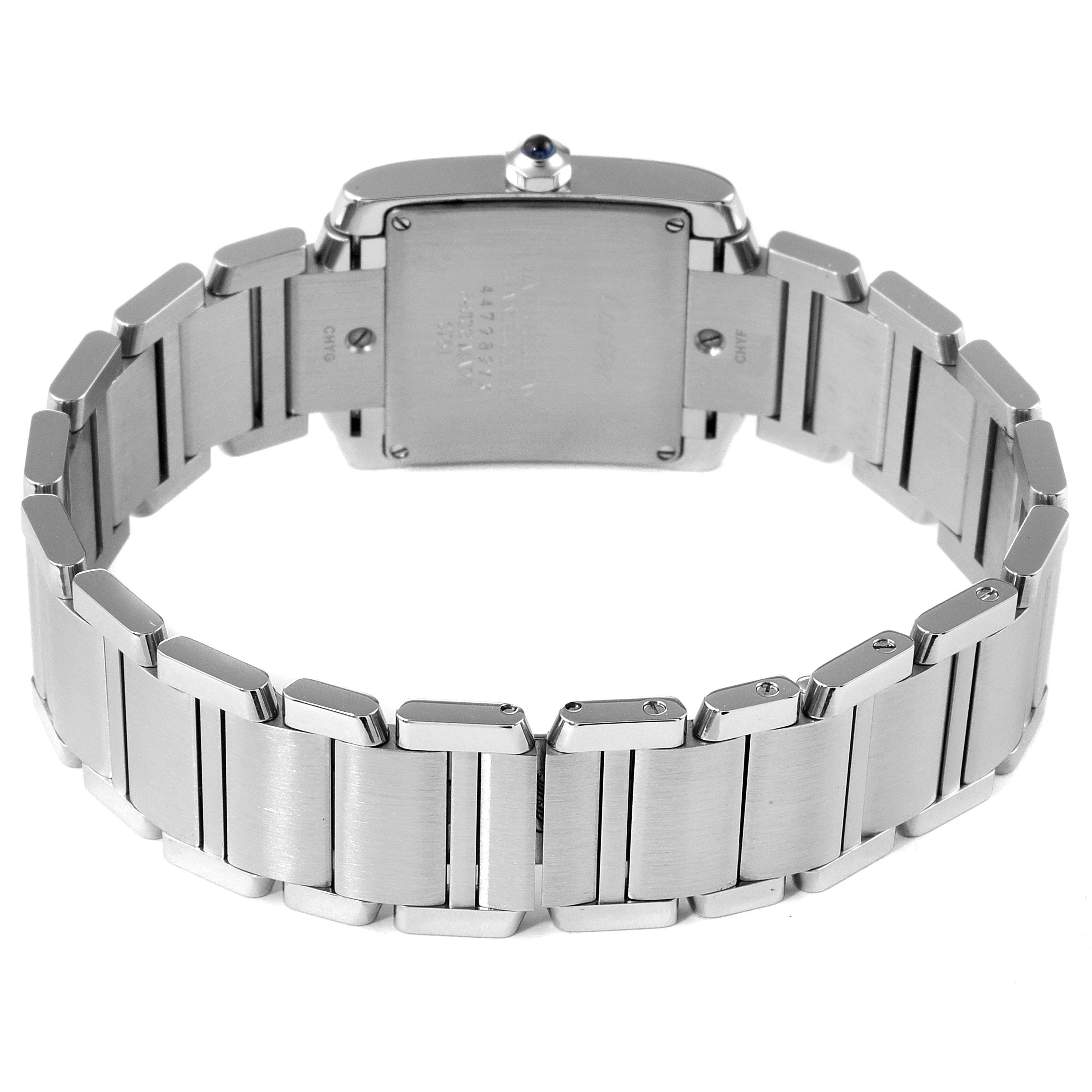 The image shows the back and bracelet of a Cartier Tank Française watch, highlighting the case back and metal links.