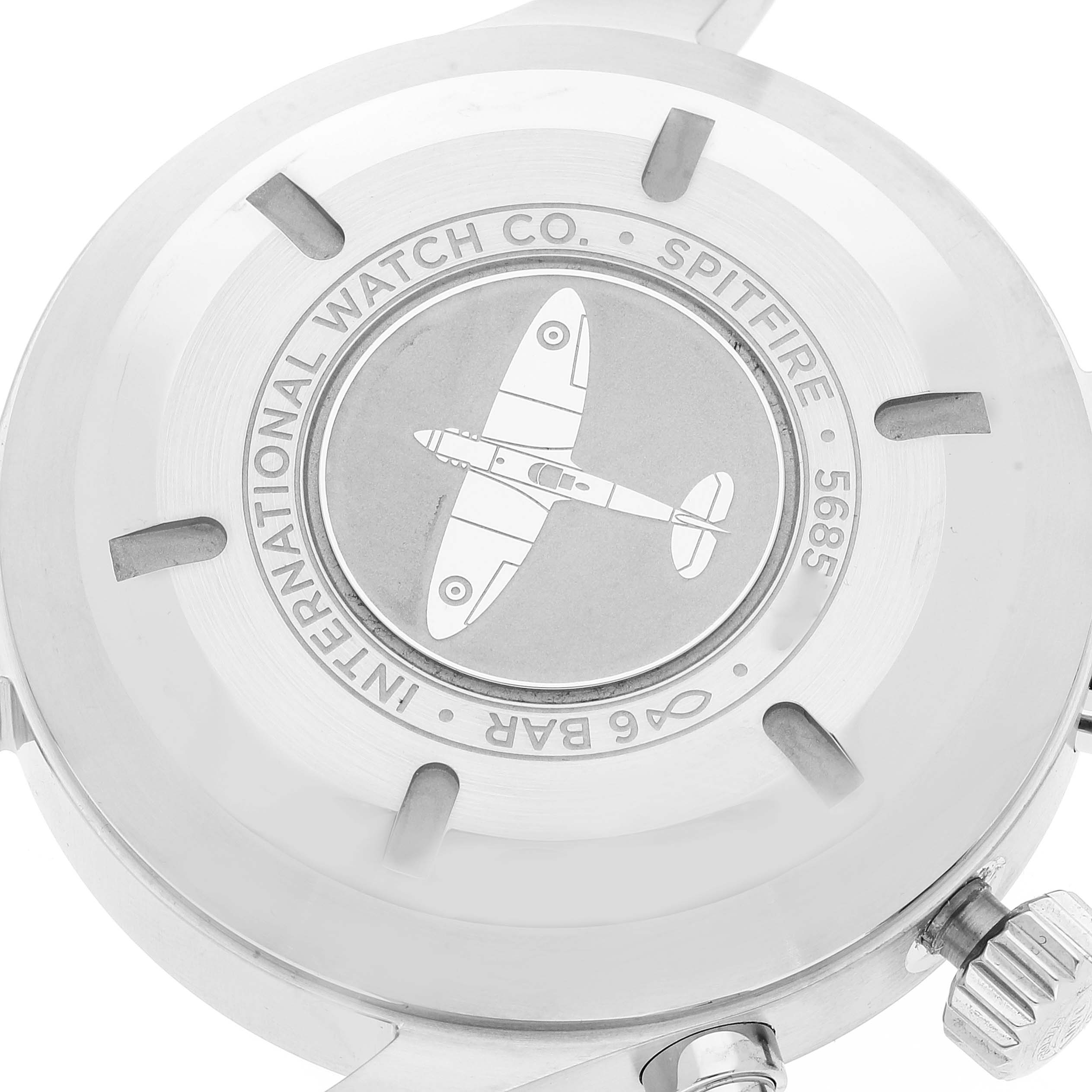 The image shows the back case of an IWC Pilot IW377719 Men's Stainless Steel Grey Dial IW377719 Men's Stainless Steel Grey Dial watch model, featuring an engraved Spitfire airplane design and branding details.