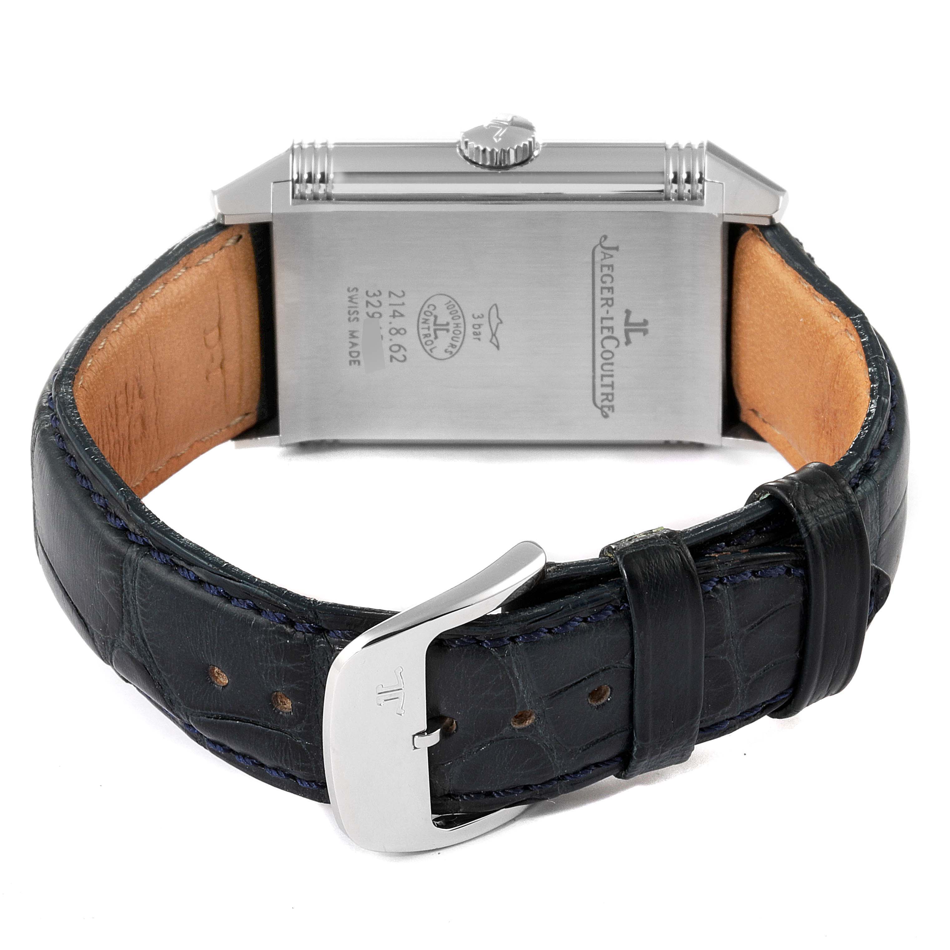 The image shows the back of the Jaeger-LeCoultre Reverso watch, highlighting the case back, leather strap, and clasp.