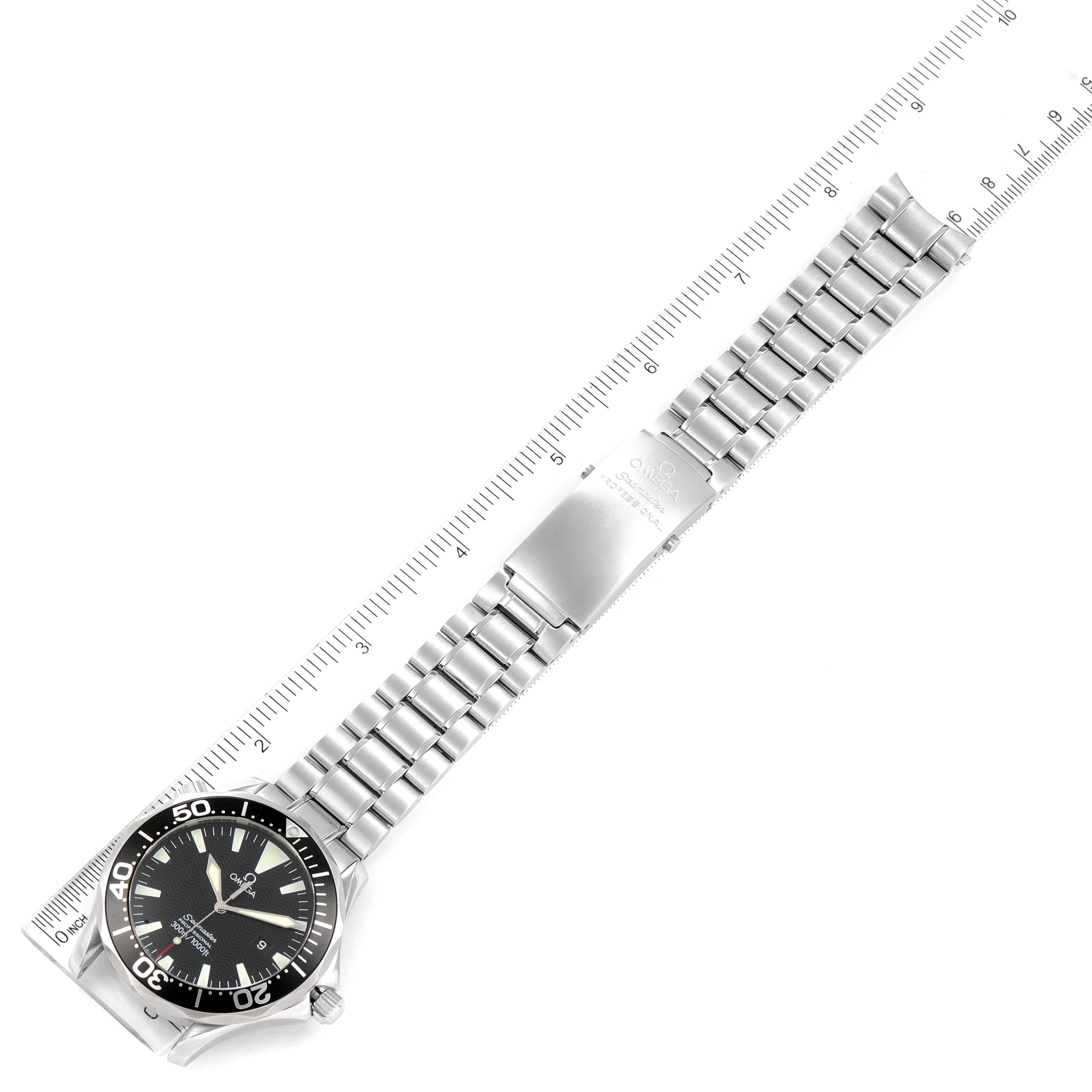 The image showcases the Omega Seamaster 2264.50.00 Men's Stainless Steel Black Dial 2264.50.00 Men's Stainless Steel Black Dial watch placed next to a ruler, displaying its face and metal bracelet from a top-down angle.