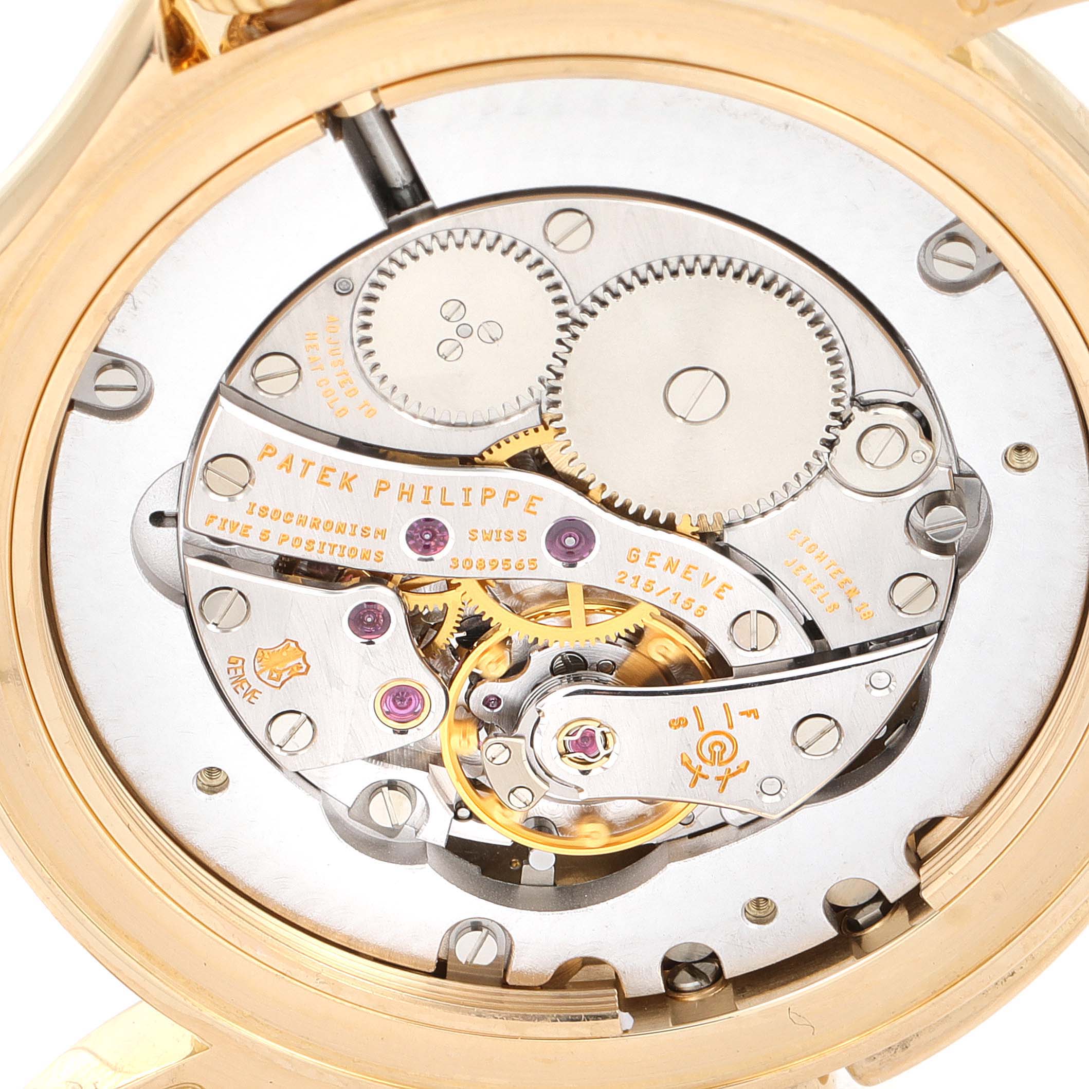 The image is a close-up of the movement and inner mechanisms of a Patek Philippe Calatrava 5134J Men's Yellow Gold White Dial 5134J Men's Yellow Gold White Dial watch.