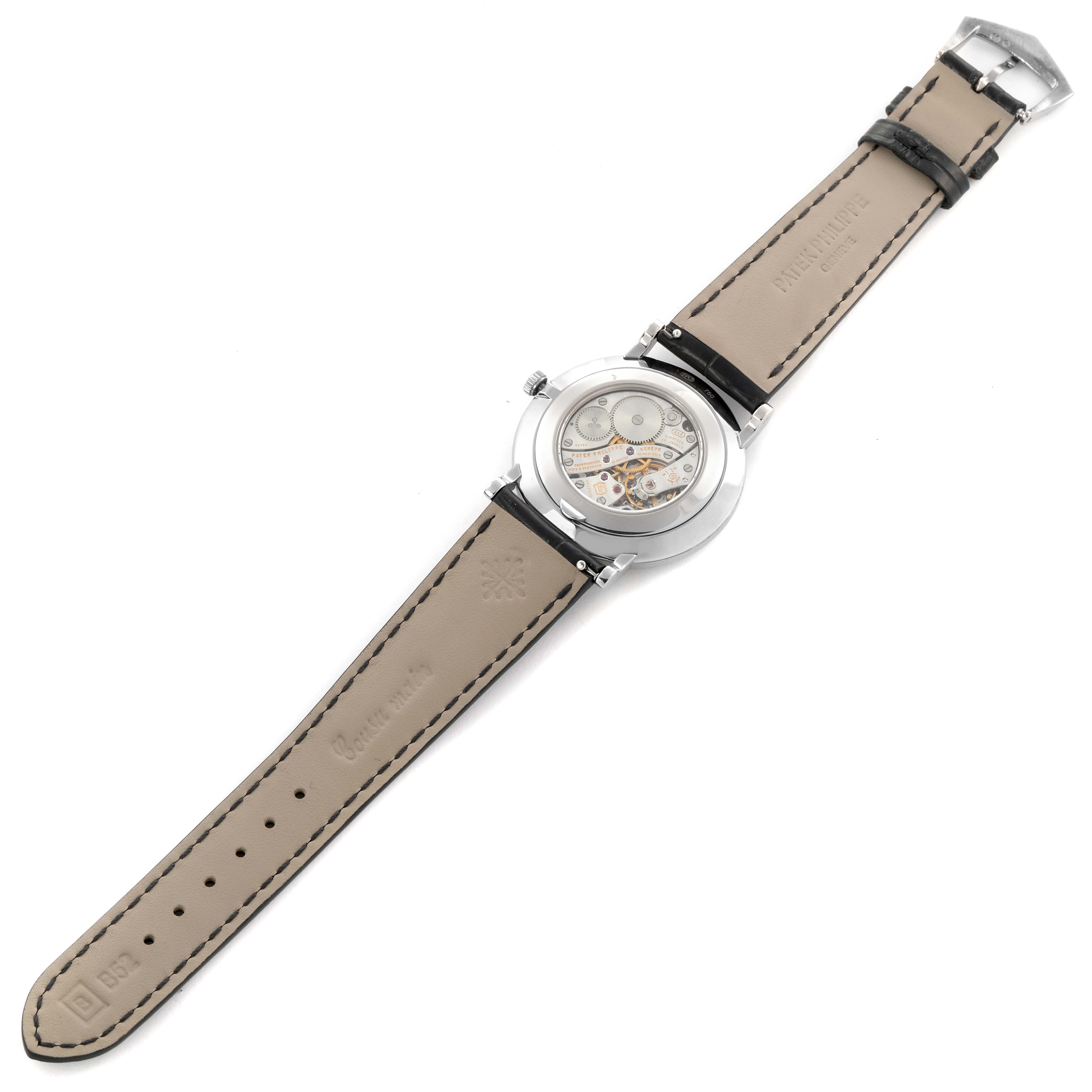 The image shows the back view of the Patek Philippe Calatrava 5116G Men's White Gold White Dial 5116G Men's White Gold White Dial, displaying its movement and leather strap.