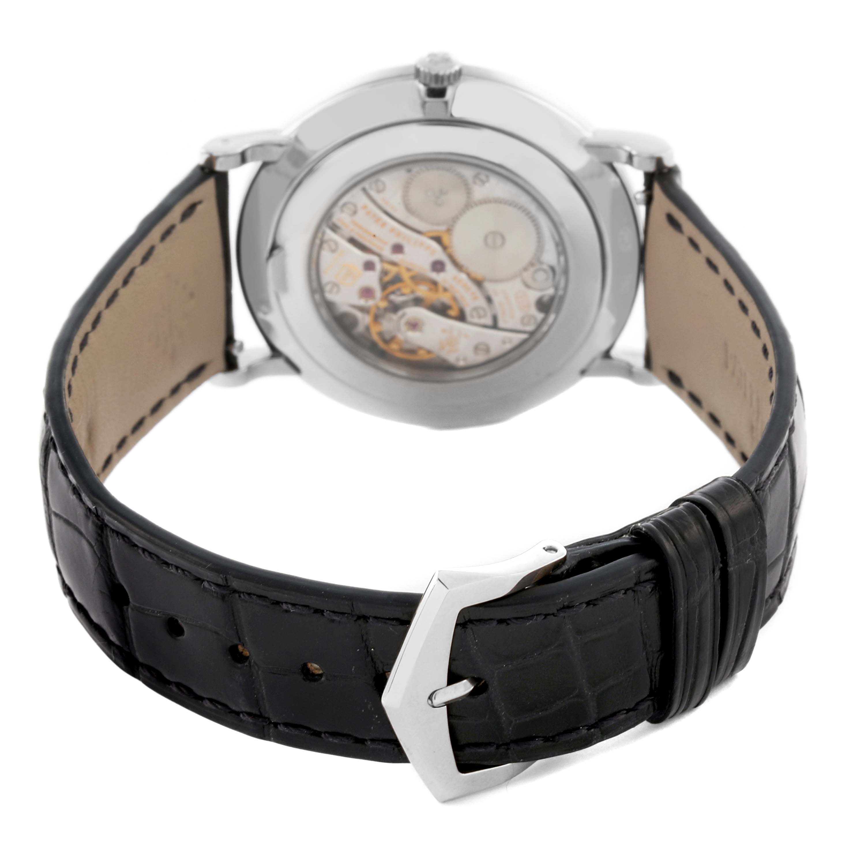 The Patek Philippe Calatrava 5116G Men's White Gold White Dial 5116G Men's White Gold White Dial watch is shown from the rear, displaying its open case back and leather strap with a buckle.