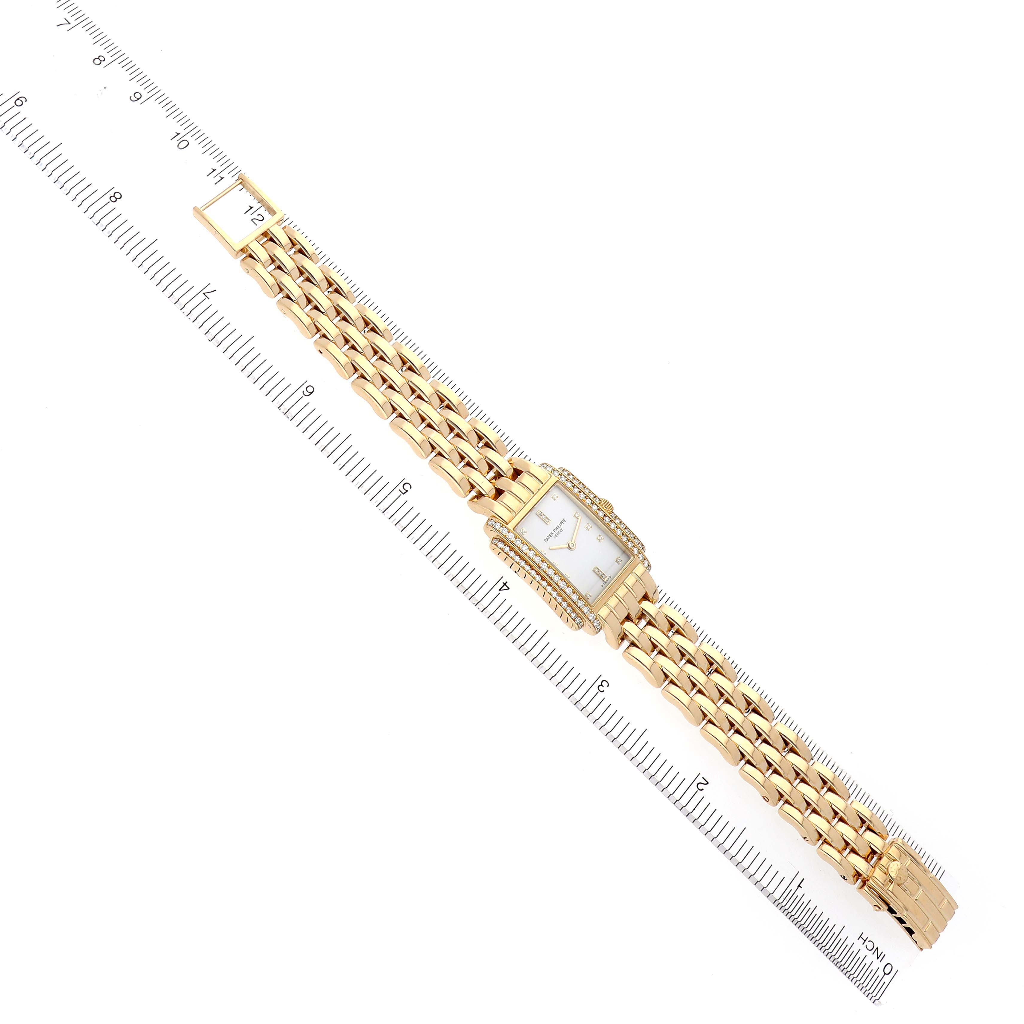 The Patek Philippe Gondolo 4825 Women's Yellow Gold White Dial 4825 Women's Yellow Gold White Dial watch is shown top-down, displaying the full bracelet, rectangular face, and diamond-set bezel.