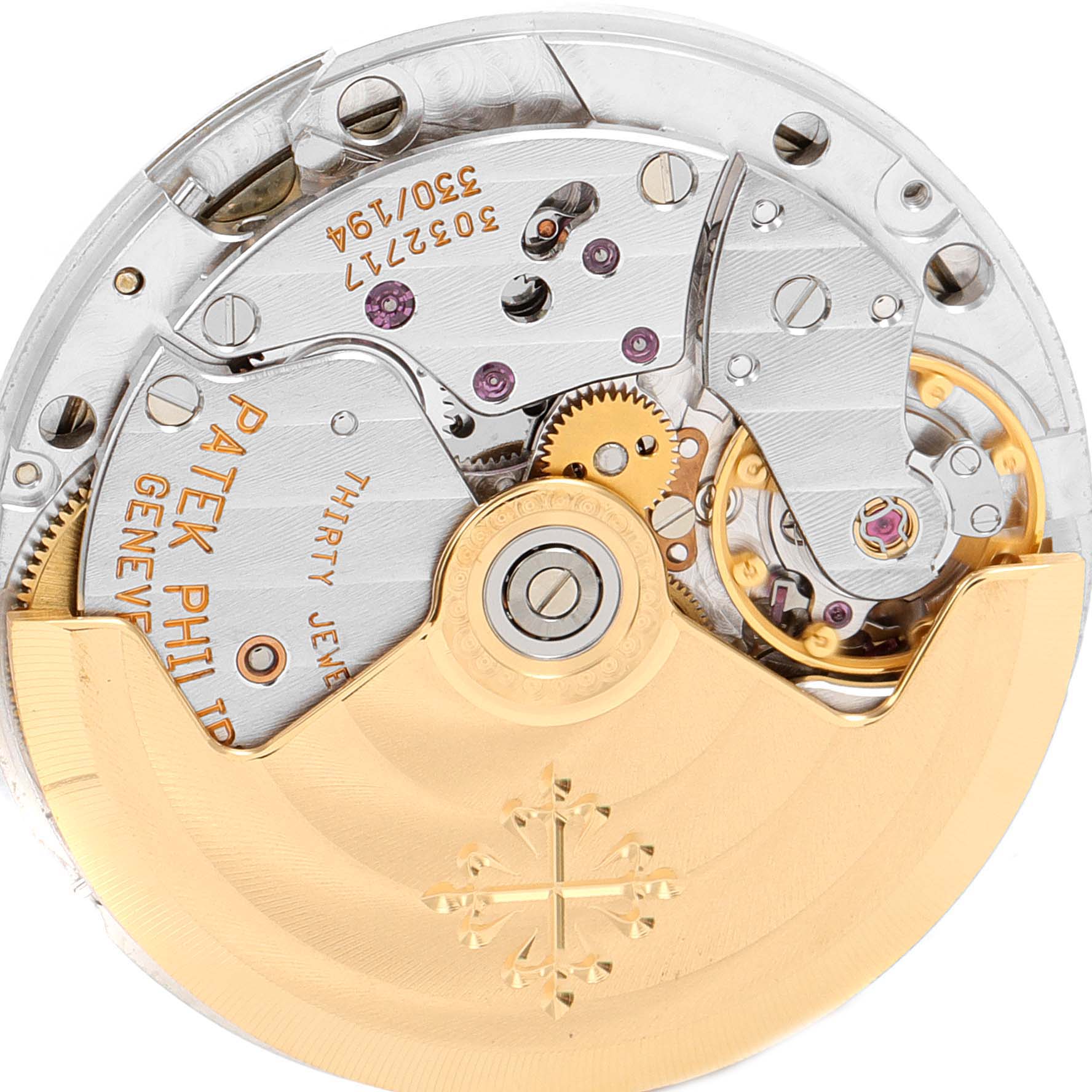 The image shows the inner mechanical movement of the Patek Philippe Nautilus 3800 Men's Yellow Gold White Dial 3800 Men's Yellow Gold White Dial watch, highlighting gears and the rotor.