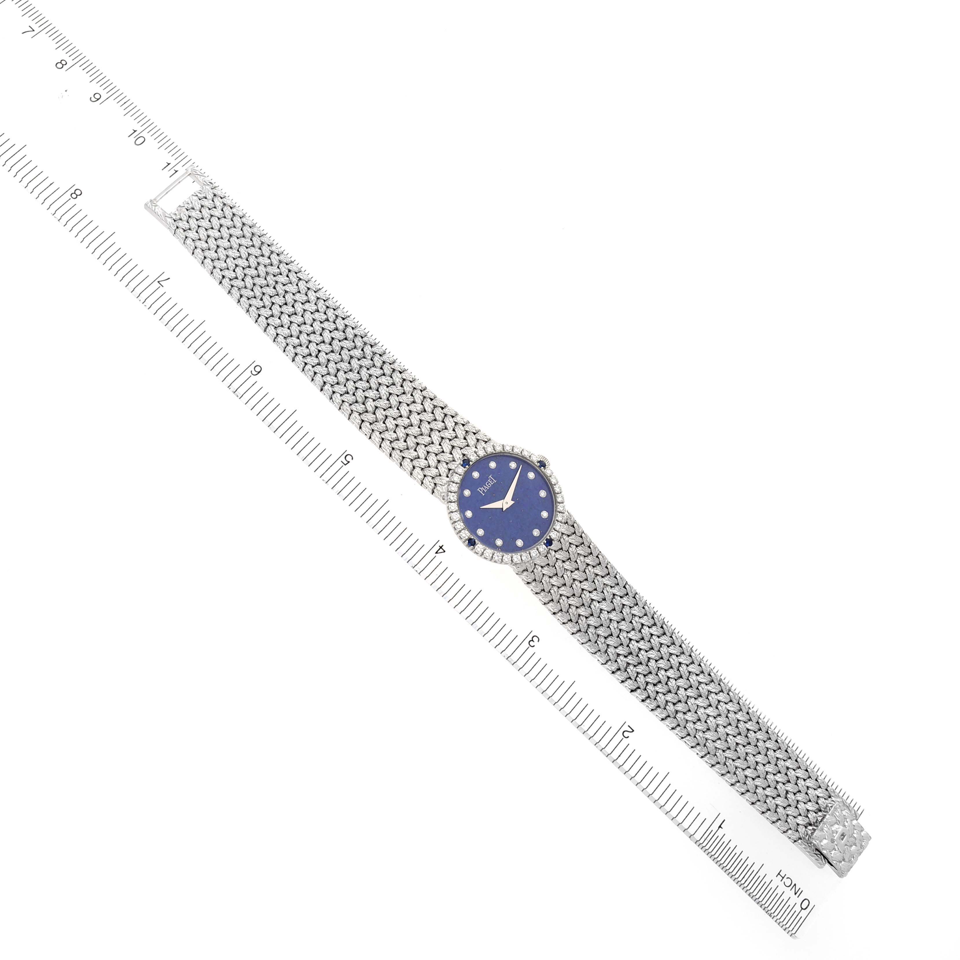 The Piaget 9706D2 Women's White Gold Blue Dial 9706D2 Women's White Gold Blue Dial Tradition 9706D2 watch is shown fully extended with a top-down view, alongside a ruler for scale.