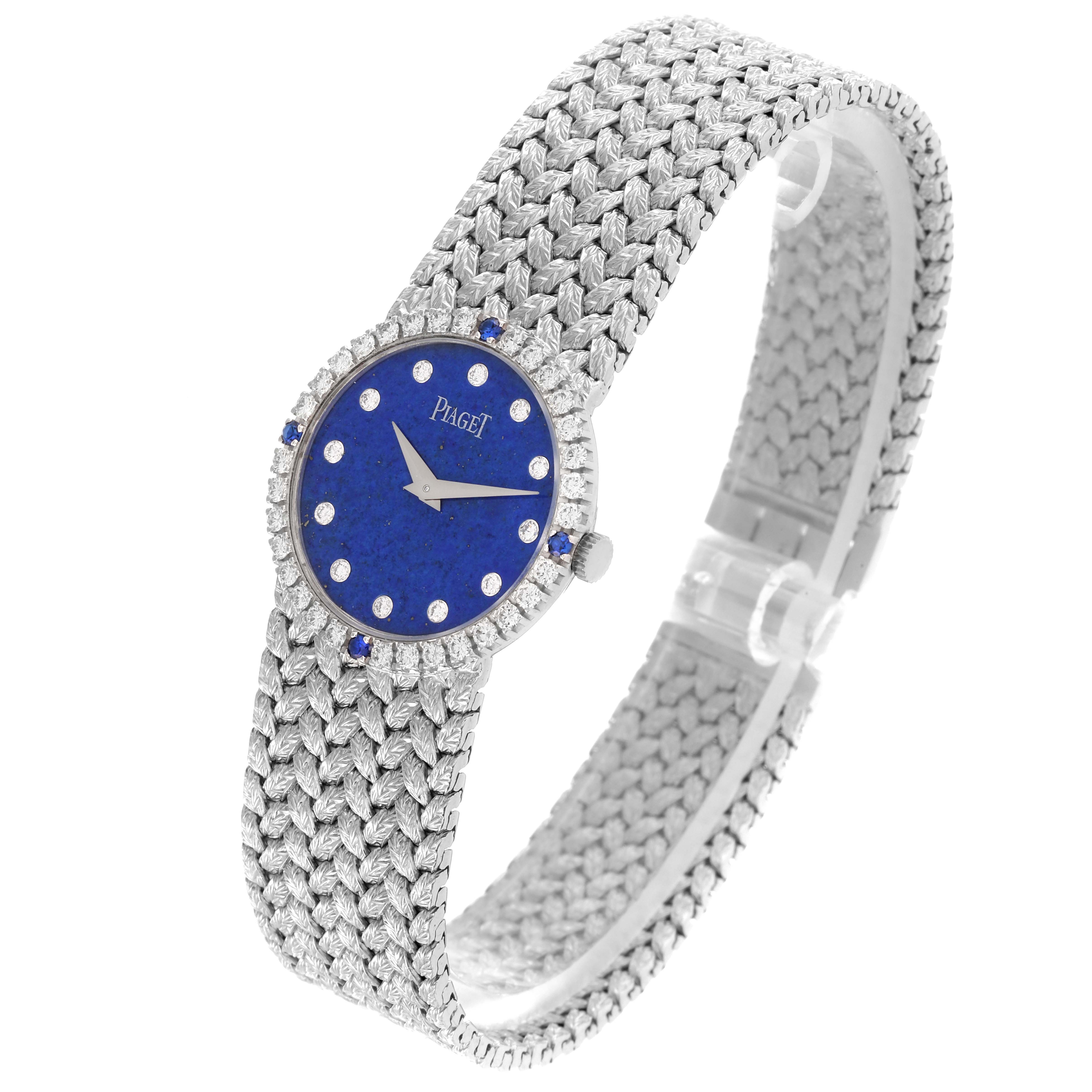The Piaget 9706D2 Women's White Gold Blue Dial 9706D2 Women's White Gold Blue Dial Tradition 9706D2 watch is shown at a slight angle highlighting the diamond bezel and woven bracelet.