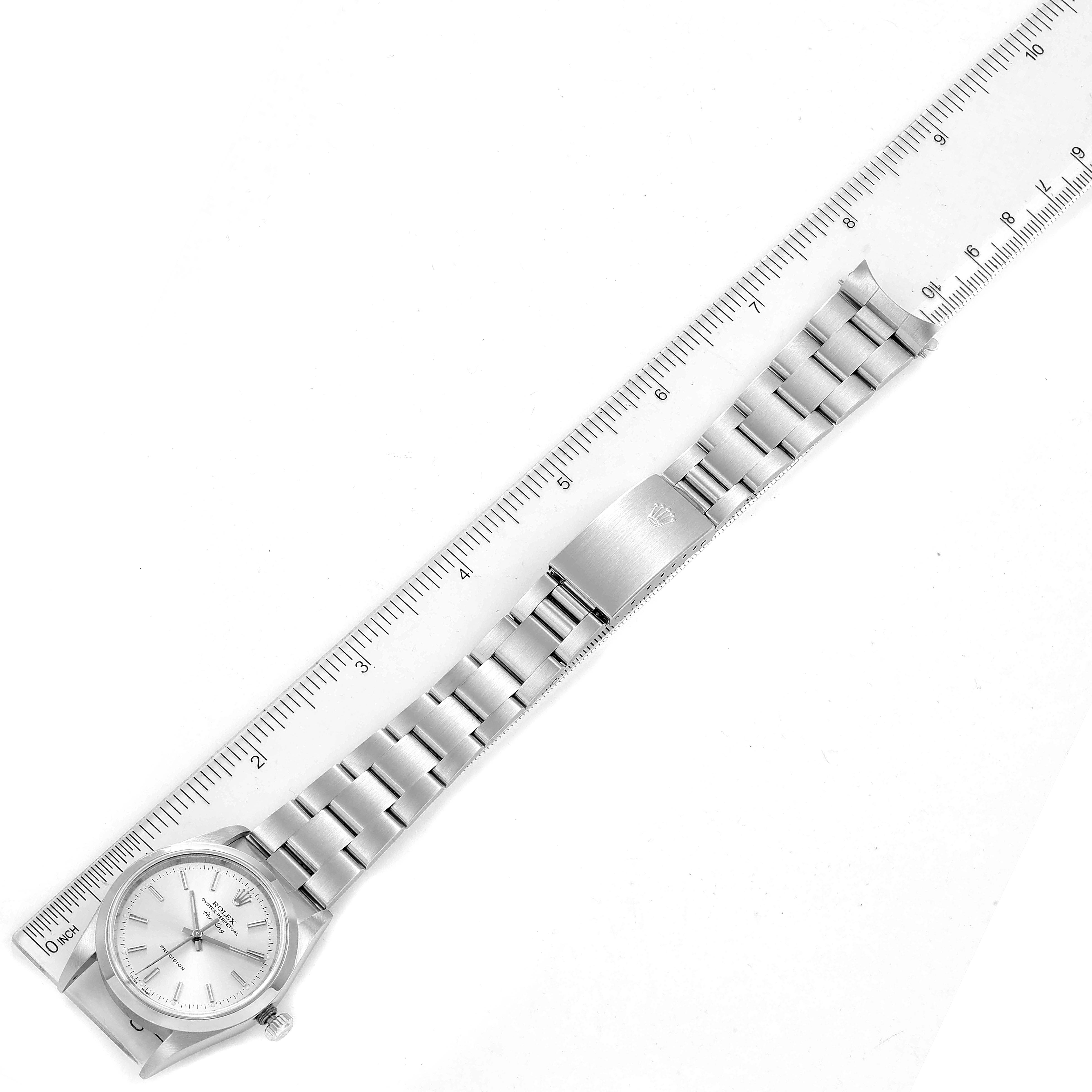 The image shows a top-down view of the Rolex Air-King 14000 Men's Stainless Steel Silver Dial 14000 Men's Stainless Steel Silver Dial watch, including the dial, bracelet, and clasp, next to a ruler for scale.