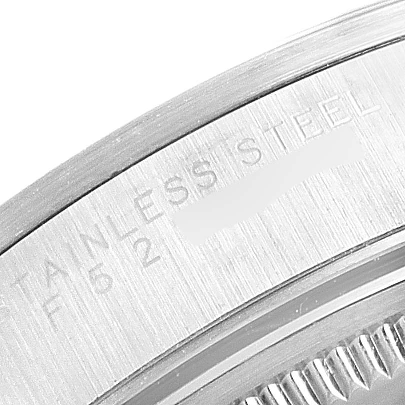 The image shows a close-up of the stainless steel bezel and partially engraved text on the Rolex Air-King 14000 Men's Stainless Steel Silver Dial 14000 Men's Stainless Steel Silver Dial watch's frame.