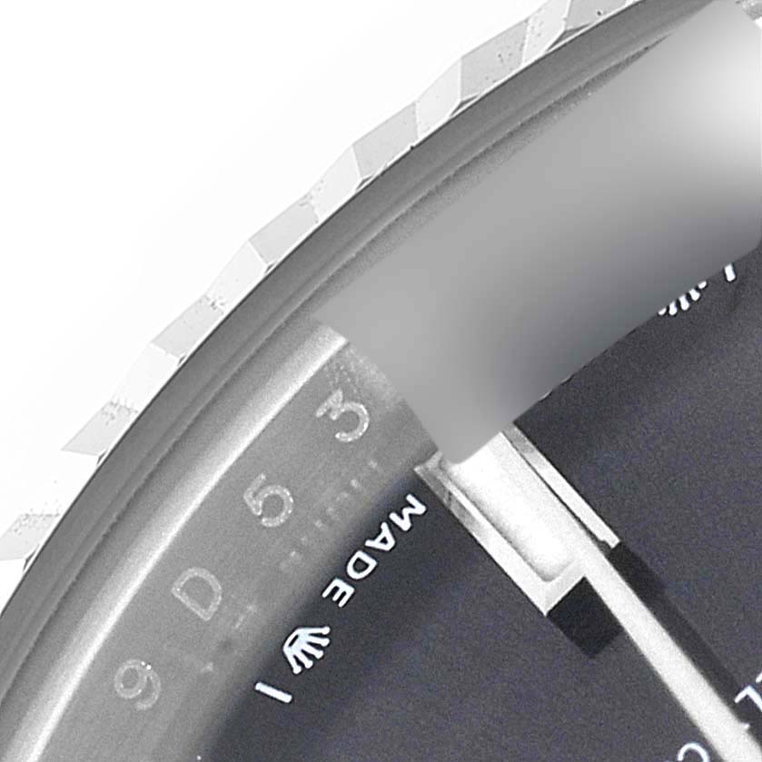 This close-up angle of the Rolex Datejust 279174 Women's Stainless Steel Grey Dial 279174 Women's Stainless Steel Grey Dial shows part of the dial, the edge of the bezel, and the "Made" part of "Made in" text.