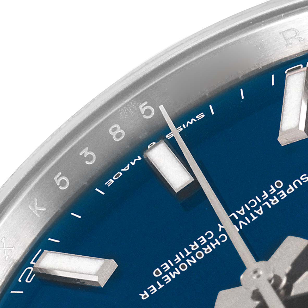 This is a close-up angle of the dial and partial bezel of a Rolex Datejust 41 126300 Men
s Stainless Steel Blue Dial 126300 Men
s Stainless Steel Blue Dial, displaying hour markers and text details.