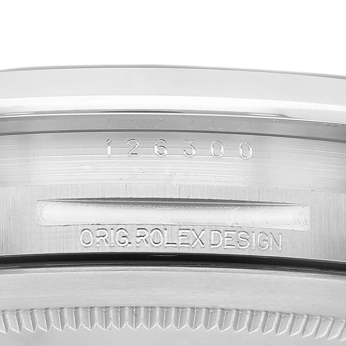This close-up image shows the Rolex Datejust 41 126300 Men
s Stainless Steel Blue Dial 126300 Men
s Stainless Steel Blue Dial model
s bezel and engravings, displaying the serial number and the text "ORIG ROLEX DESIGN."