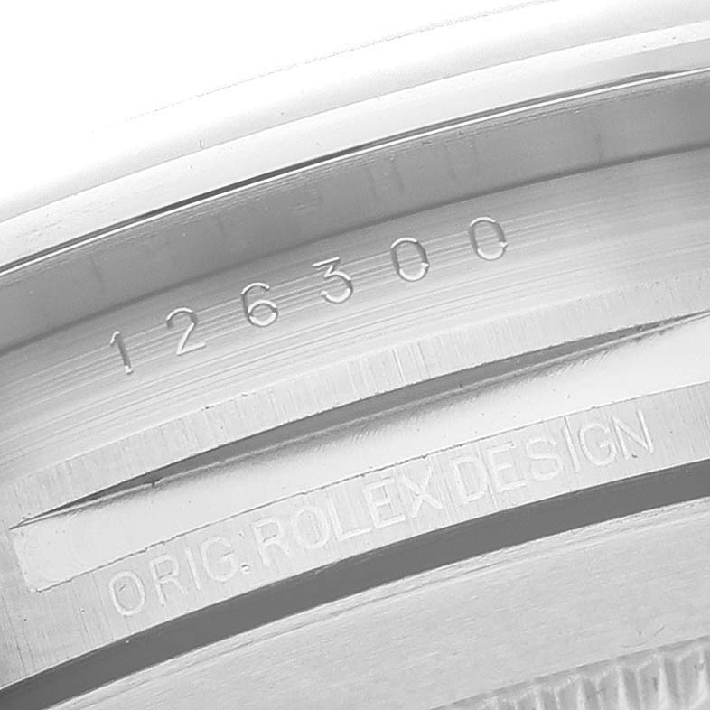 This close-up image shows the engraved serial number and "ORIG. ROLEX DESIGN" text inside the case of the Rolex Datejust 41 126300 Men
s Stainless Steel Blue Dial 126300 Men
s Stainless Steel Blue Dial.