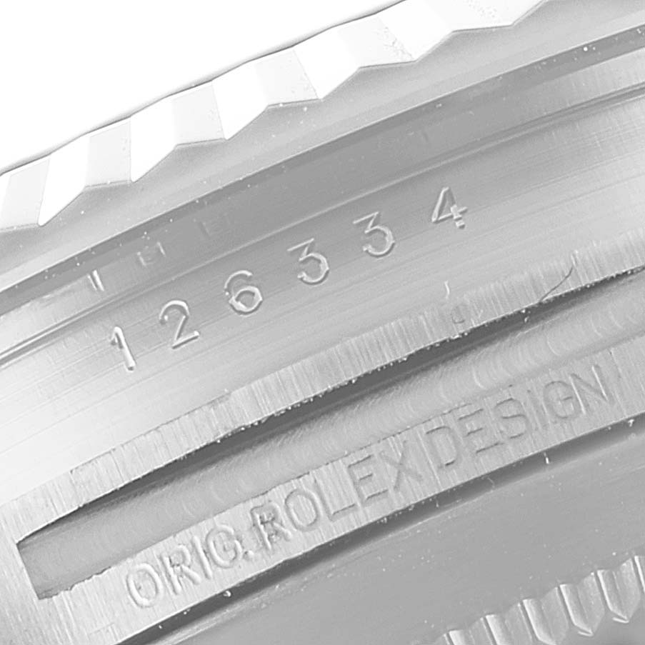 This close-up image of a Rolex Datejust 41 126334 Men's Stainless Steel Blue Dial 126334 Men's Stainless Steel Blue Dial watch shows part of the bezel and the engraved model number 126334.