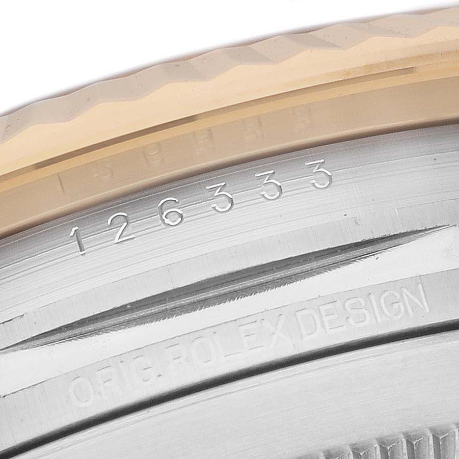 This image shows a close-up of the edge of the bezel and the case of the Rolex Datejust 41 126333 Men's Steel and Gold (two tone) Grey Dial 126333 Men's Steel and Gold (two tone) Grey Dial watch with visible engravings.