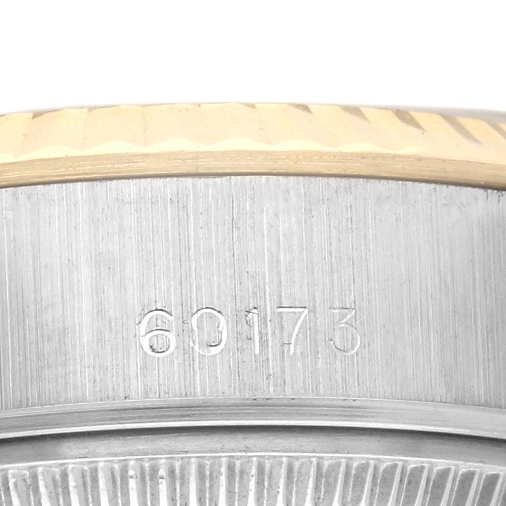 The image shows a close-up of the Rolex Datejust 69173 Women's Steel and Gold (two tone) Black Dial 69173 Women's Steel and Gold (two tone) Black Dial model's bezel and case edge with a visible reference number.