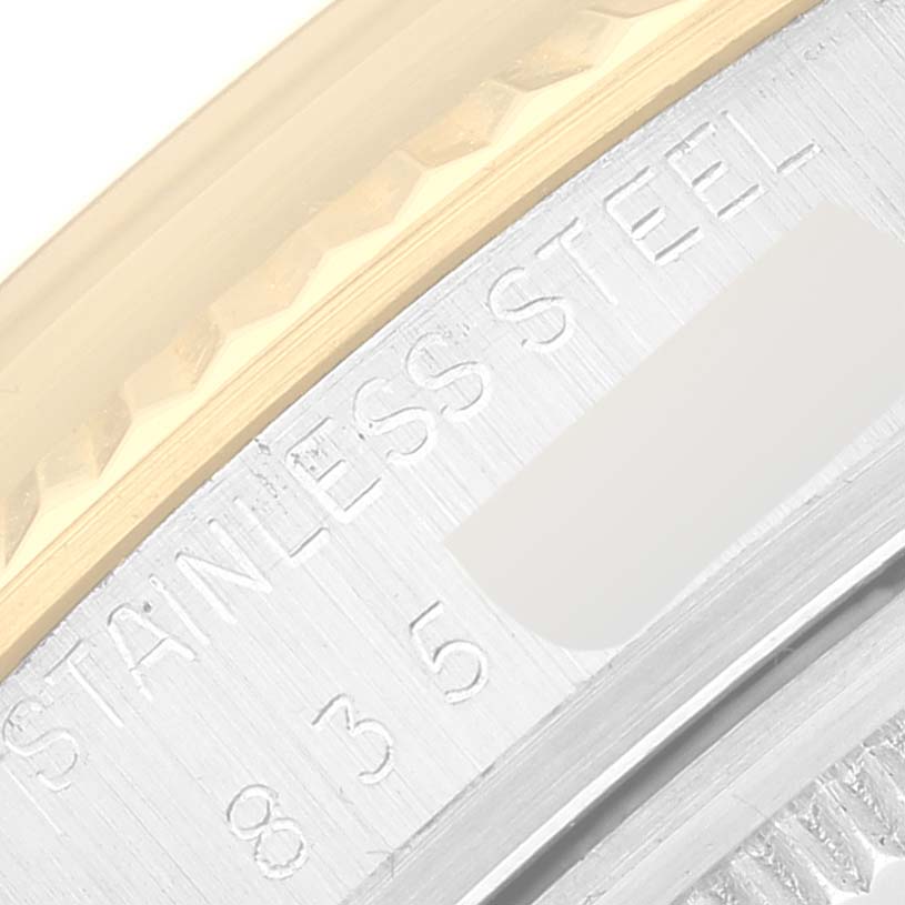 This image shows a close-up of the stainless steel and gold bezel of a Vintage Collection model by Rolex.