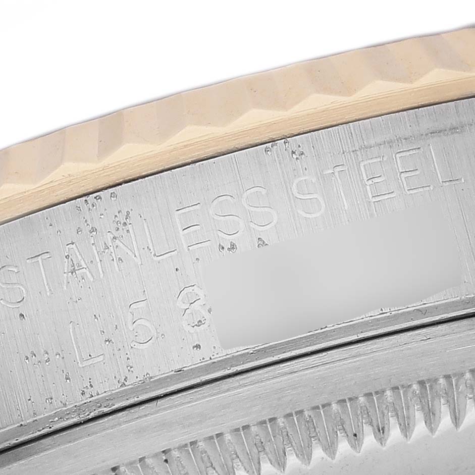 This image shows a close-up of the stainless steel bezel and case side of a Rolex Datejust 16233G Men's Steel and Gold (two tone) Blue Dial 16233G Men's Steel and Gold (two tone) Blue Dial watch.