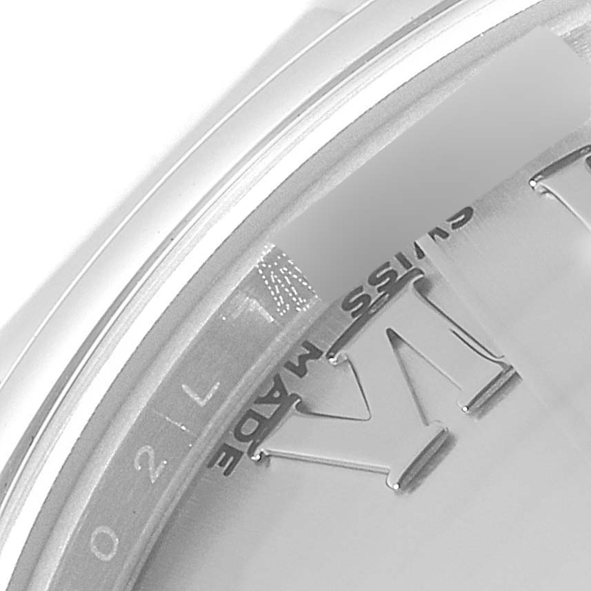 The image shows a close-up of the dial edge and part of the bezel of the Mid-Size Rolex watch, displaying "Swiss Made".