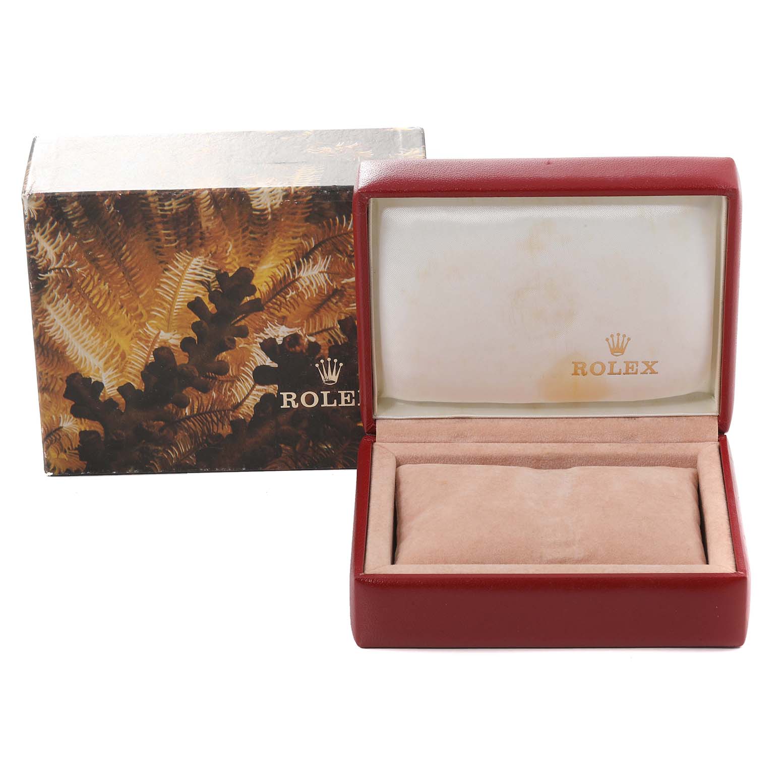 The image shows an open Rolex watch box with the brand's logo and an outer box with decorative design.