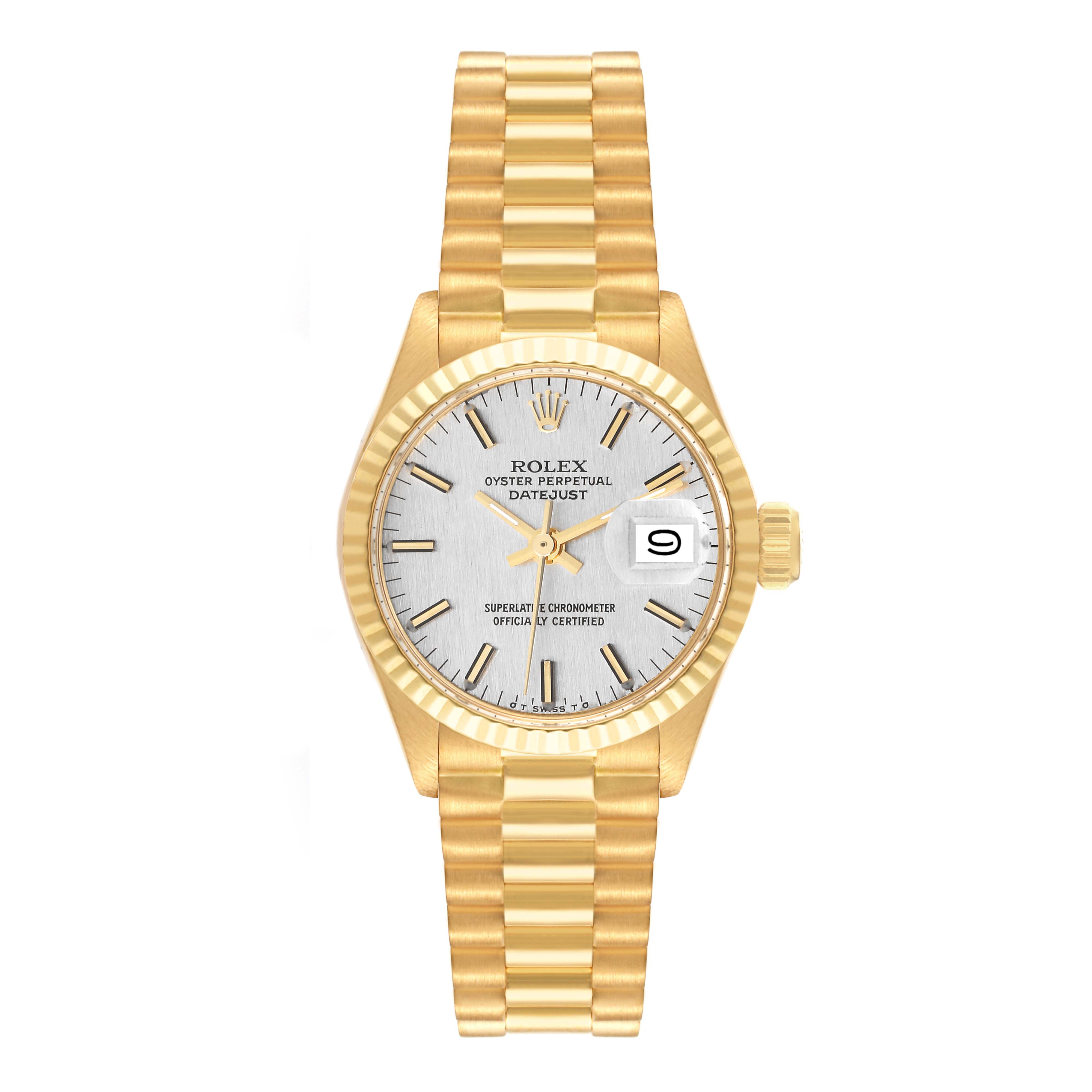 The image shows a front view of a Rolex President 6917 Women's Yellow Gold Silver Dial 6917 Women's Yellow Gold Silver Dial model watch, including its gold bracelet, silver dial, date window, and fluted bezel.