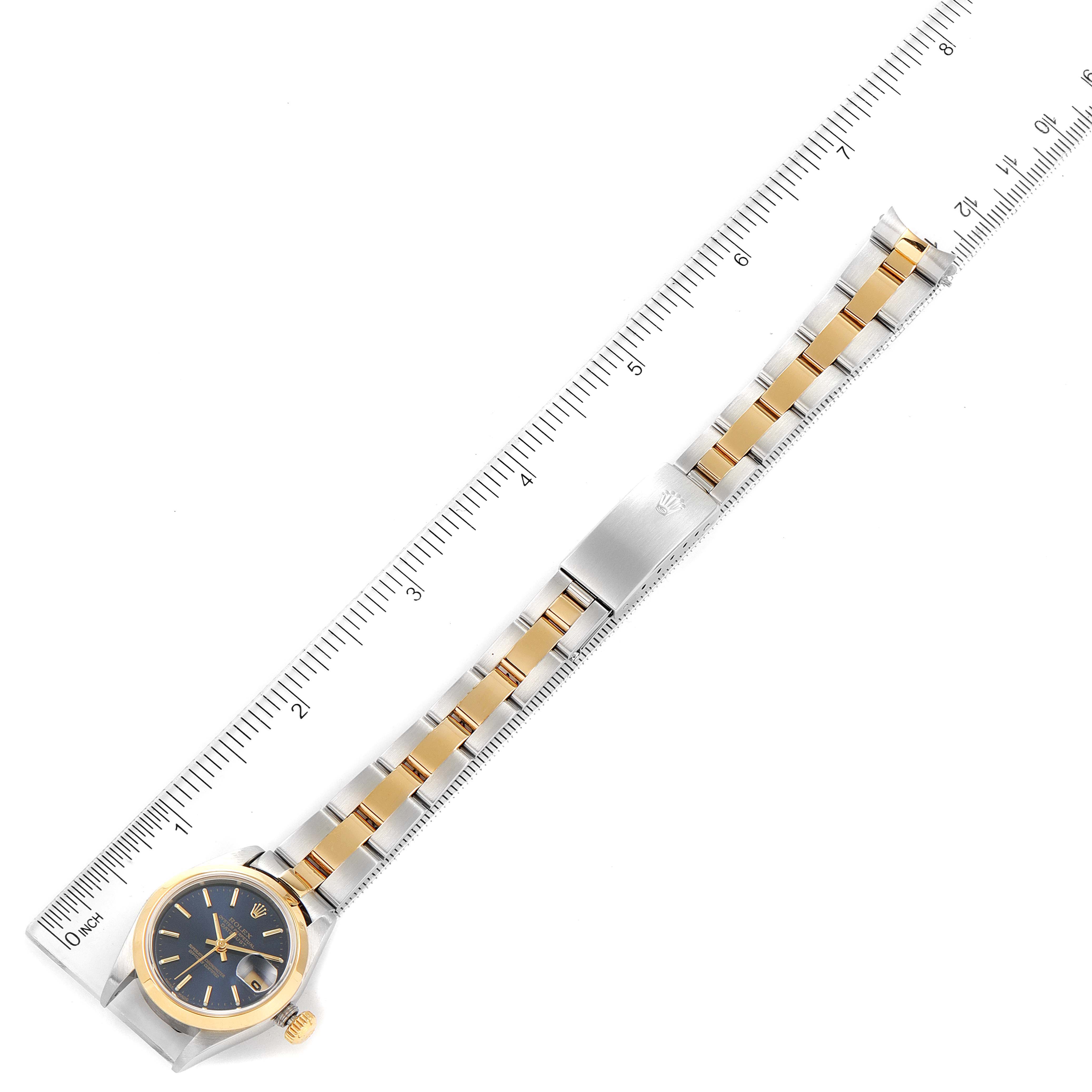 The image shows the Rolex Datejust 79163 Women's Steel and Gold (two tone) Blue Dial 79163 Women's Steel and Gold (two tone) Blue Dial watch laid flat, with the face, bracelet, and measuring ruler visible.