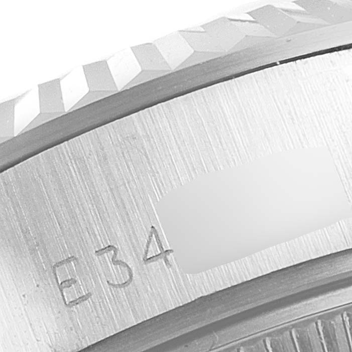 This close-up image shows part of the bezel and the engraved serial number of a Rolex Datejust 69174 Women
s Stainless Steel Silver Dial 69174 Women
s Stainless Steel Silver Dial watch.