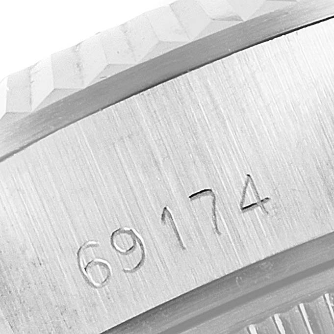 Close-up of the engraved serial number on the case of a Rolex Datejust 69174 Women
s Stainless Steel Silver Dial 69174 Women
s Stainless Steel Silver Dial watch model.