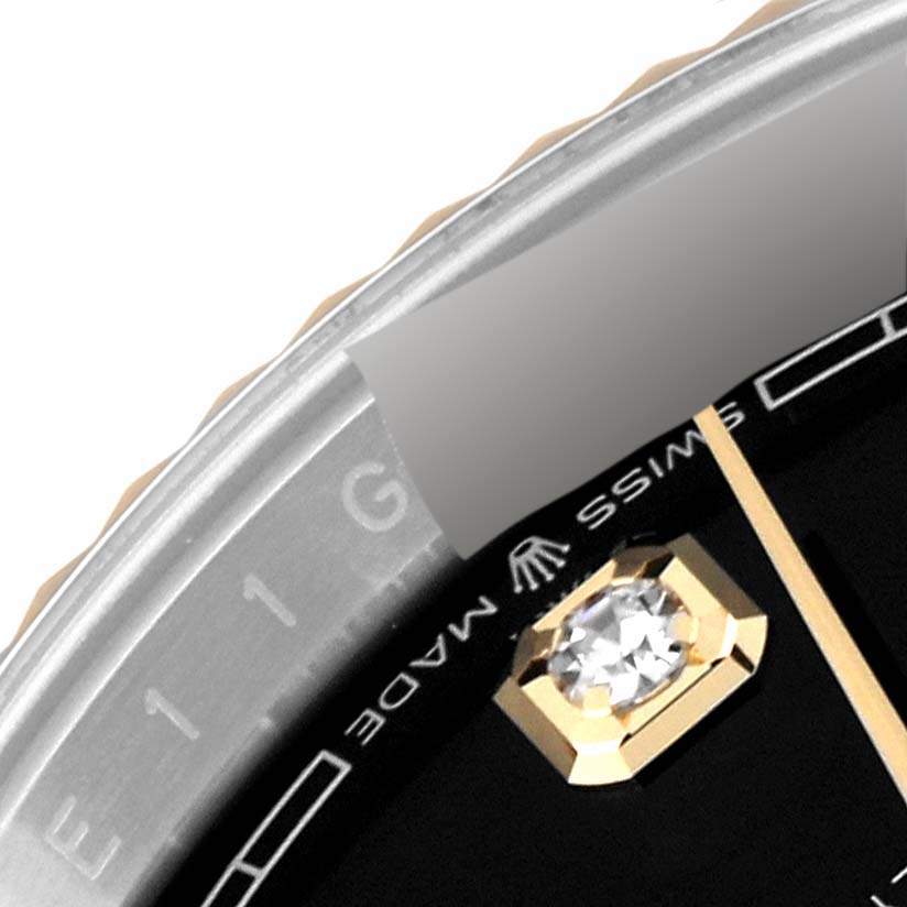 This close-up image shows the bezel, part of the dial, and a diamond marker of a Rolex Datejust 126233 Men's Steel and Gold (two tone) Black Dial 126233 Men's Steel and Gold (two tone) Black Dial watch.