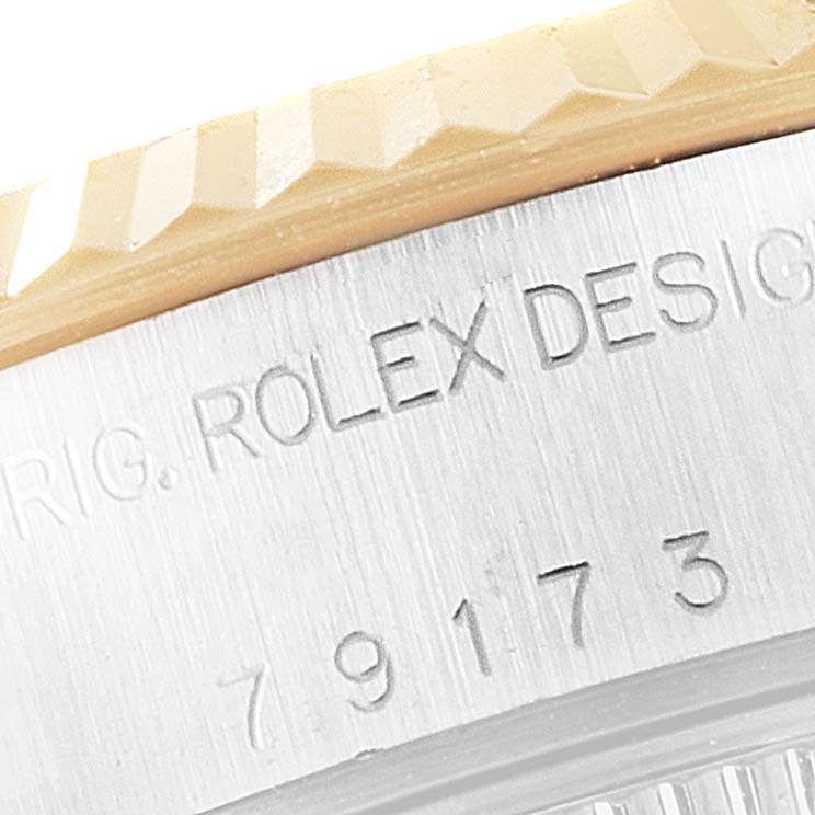 This close-up image shows the serial number area and part of the bezel of a Rolex Datejust 79173 Women's Steel and Gold (two tone) Blue Dial 79173 Women's Steel and Gold (two tone) Blue Dial watch.