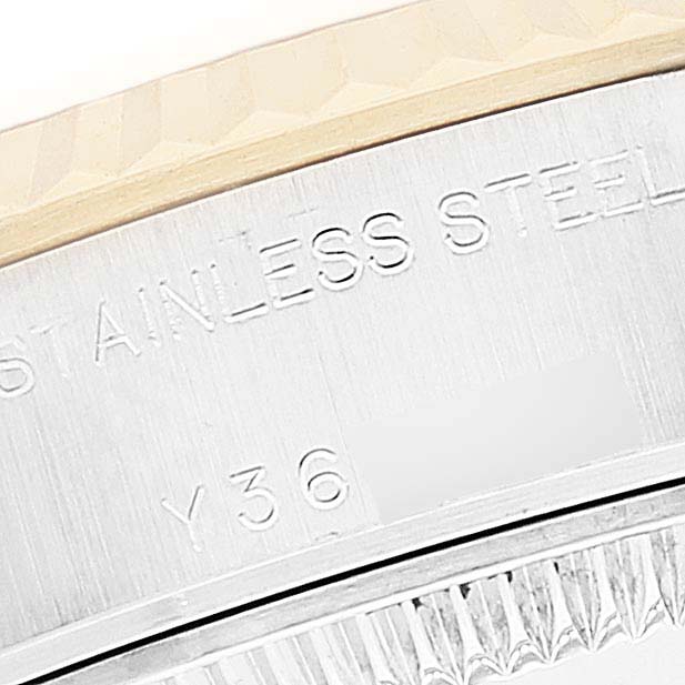 This close-up image shows a portion of the bezel and the engraved markings on the case of a Rolex Datejust 79173 Women's Steel and Gold (two tone) Champagne Dial 79173 Women's Steel and Gold (two tone) Champagne Dial watch.