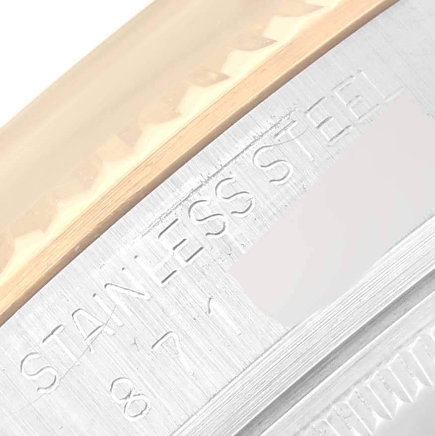 The image shows a close-up of the upper casing and edge inscription of a Vintage Collection Rolex watch.