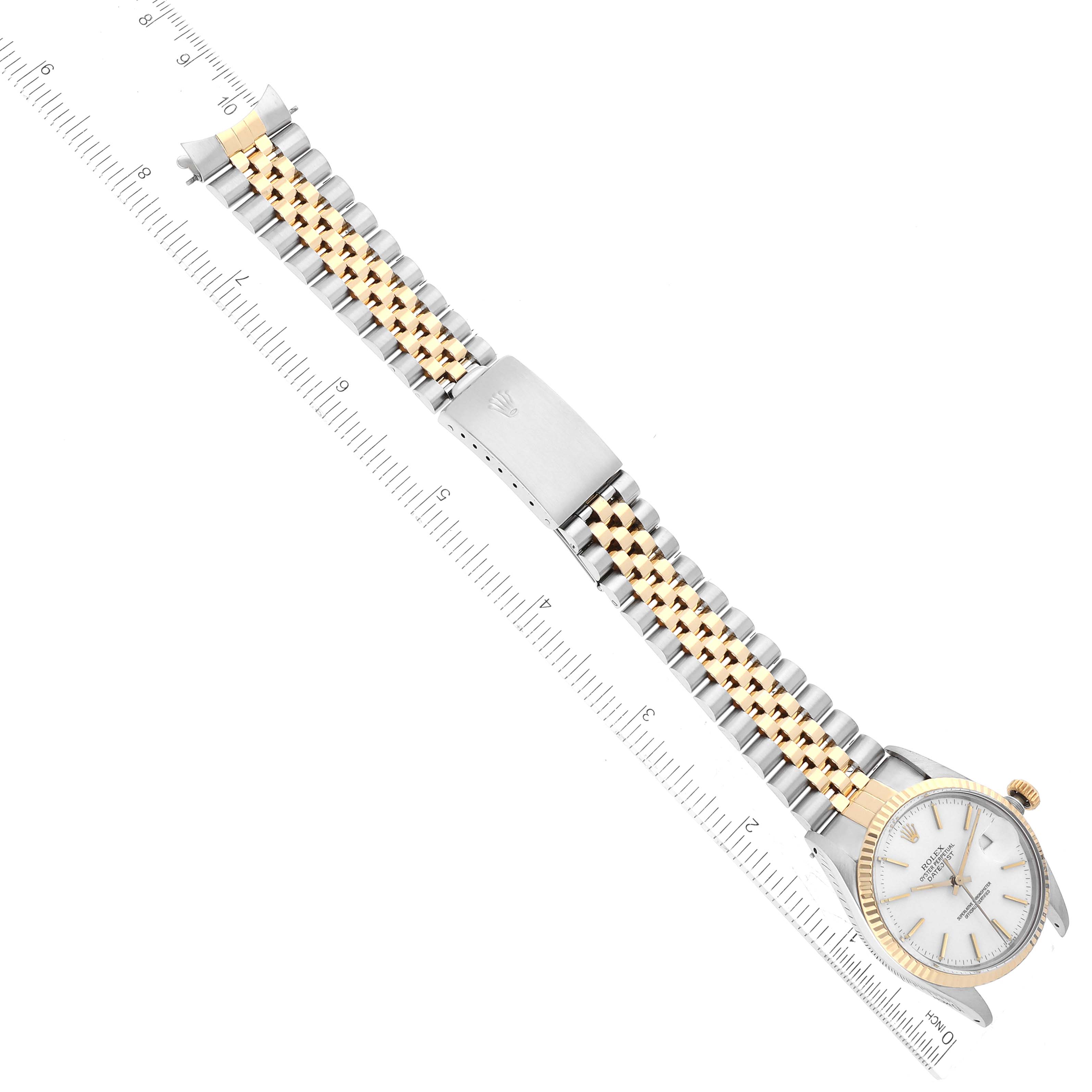 The Rolex Vintage Collection 16013 Men's Steel and Gold (two tone) White Dial 16013 Men's Steel and Gold (two tone) White Dial watch is shown from a top-down angle, featuring its face, bracelet, and clasp along a ruler.