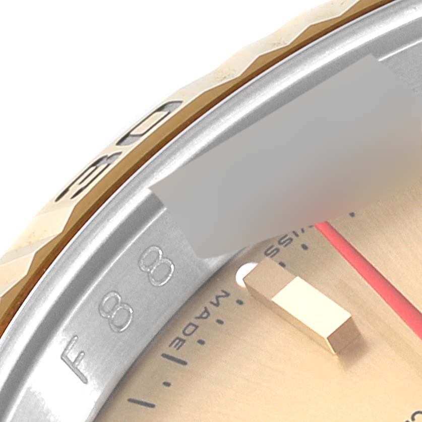 This image shows a close-up angle of a Rolex Turn-o-Graph 116263 Men's Steel and Gold (two tone) Champagne Dial 116263 Men's Steel and Gold (two tone) Champagne Dial watch's bezel and part of the dial.