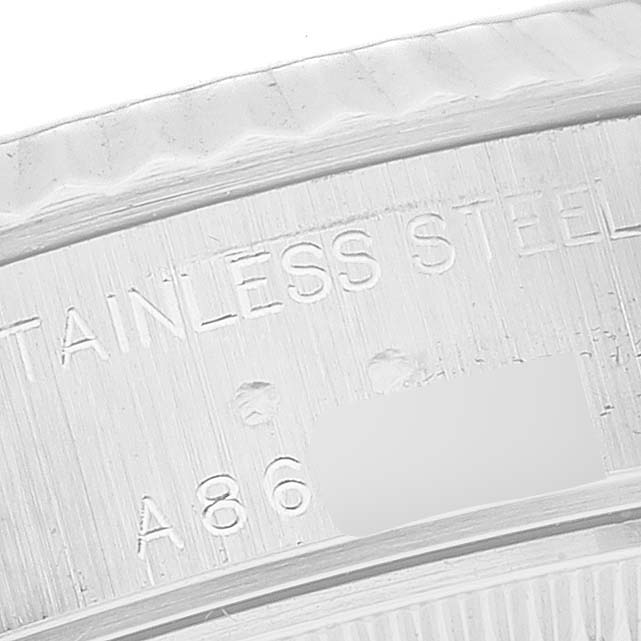 The image displays a close-up of the serial number and "STAINLESS STEEL" engraving on a Rolex Datejust 79174 Women's Stainless Steel Silver Dial 79174 Women's Stainless Steel Silver Dial watch.